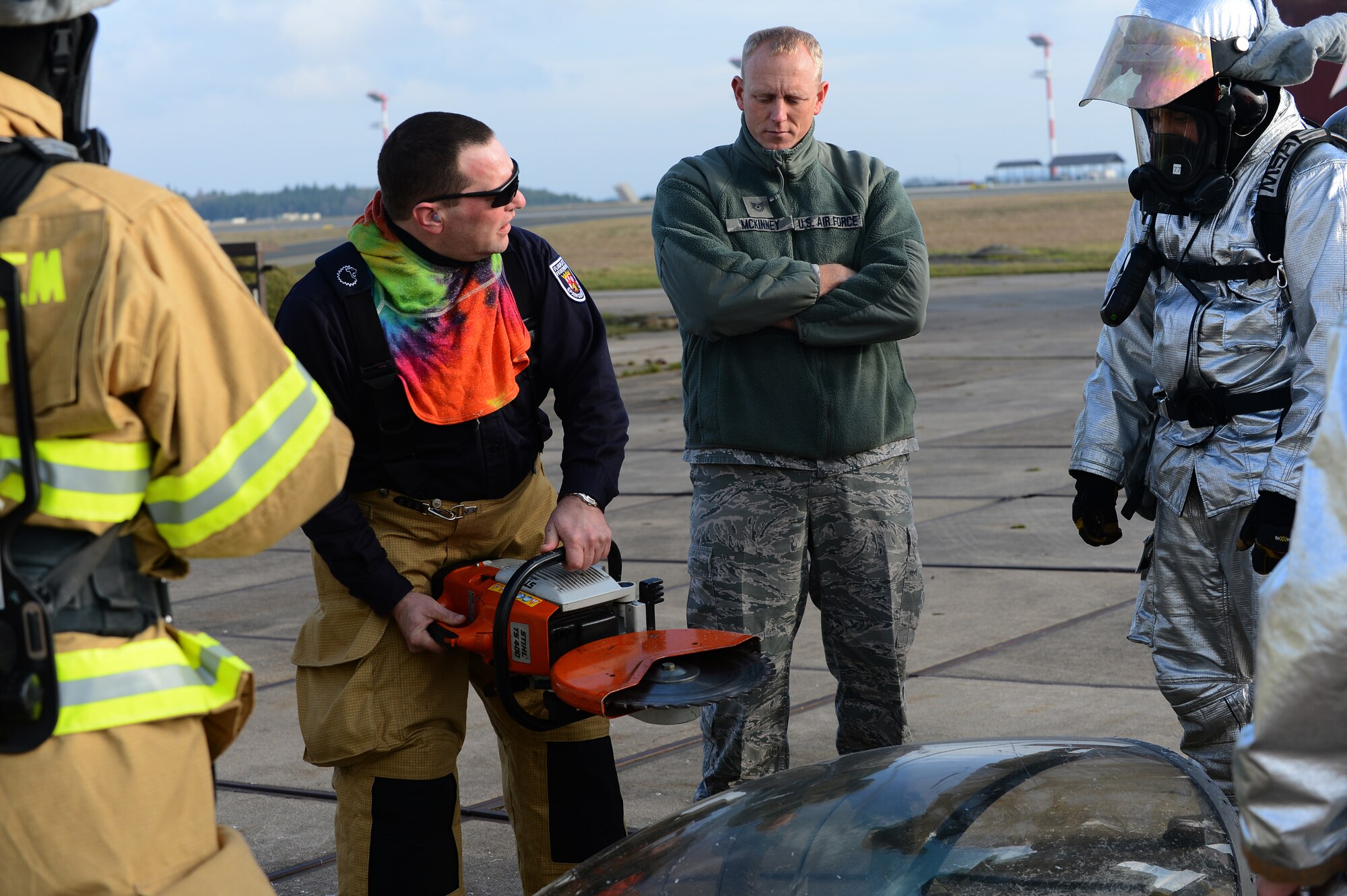 SPANGDAHLEM AIR BASE, Germany – Karsten Kurtze, second from left, 52nd Civil Engineer Squadron crew chief from Speicher, Germany, teaches fellow firefighters how to use a circular saw during emergency egress training outside the Spangdahlem fire station, Jan. 7, 2013. Part of emergency egress training involves learning how to safely use equipment. (U.S. Air Force photo by Airman 1st Class Dillon Davis/Released)