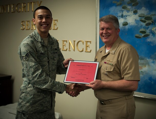Senior Airman Matthew Baxter, 628th Security Forces Squadron, presents Capt. Thomas Bailey, Joint Base Charleston deputy commander, the award for most original chili during the Commanders Chili Cook-off Jan. 4, 2012, at Joint Base Charleston – Air Base, S.C. Commanders from several JB Charleston commands participated by bringing in their own style of chili and opened the event for Airmen to sample their creations. All proceeds from the cook-off went to Airmen Against Drunk Driving. (U.S. Air Force photo/Airman 1st Class Tom Brading)

