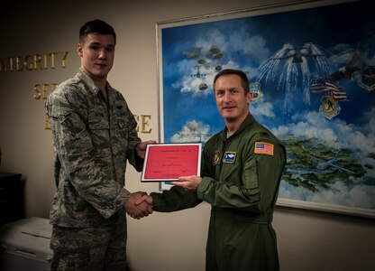 Airman Derek Severson, 15th Airlift Squadron loadmaster, presents Col. James Fontanella, 315th Airlift Wing commander, the award for best overall chili during the Commanders Chili Cook-off, Jan. 4, 2012, at Joint Base Charleston – Air Base, S.C. Commanders from several JB Charleston commands participated by bringing in their own style of chili and opened the event for Airmen to sample their creations. All proceeds from the cook-off went to Airmen Against Drunk Driving. (U.S. Air Force photo/Airman 1st Class Tom Brading)