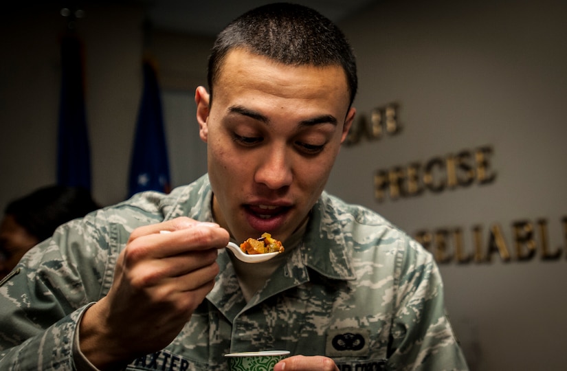 Senior Airman Matthew Baxter, 628th Security Forces Squadron, judges an entry at the Commanders Chili Cook-off Jan. 4, 2012, at Joint Base Charleston – Air Base, S.C. Commanders from several JB Charleston commands participated by bringing in their own style of chili and opened the event for Airmen to sample their creations. All proceeds from the cook-off went to Airmen Against Drunk Driving. (U.S. Air Force photo/Airman 1st Class Tom Brading)