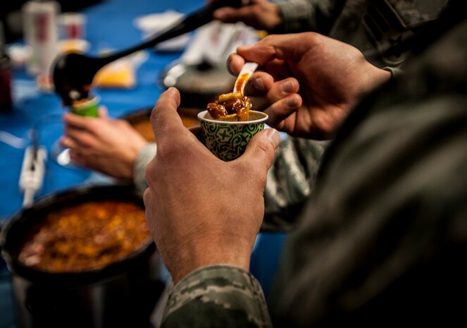 Senior Airman Herschell Miller, 437th Airlift Wing Maintenance Squadron, Precision Measurement Equipment Laboratory technician , judges a spoonful of chili from his sample cup during the Commanders Chili Cook-off Jan. 4, 2012, at Joint Base Charleston – Air Base, S.C. Commanders from several JB Charleston commands participated by bringing in their own style of chili and opened the event for Airmen to sample their creations. All proceeds from the cook-off went to Airmen Against Drunk Driving. (U.S. Air Force photo/Airman 1st Class Tom Brading)
