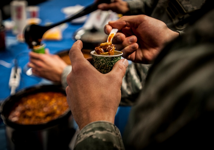 Senior Airman Herschell Miller, 437th Airlift Wing Maintenance Squadron, Precision Measurement Equipment Laboratory technician , judges a spoonful of chili from his sample cup during the Commanders Chili Cook-off Jan. 4, 2012, at Joint Base Charleston – Air Base, S.C. Commanders from several JB Charleston commands participated by bringing in their own style of chili and opened the event for Airmen to sample their creations. All proceeds from the cook-off went to Airmen Against Drunk Driving. (U.S. Air Force photo/Airman 1st Class Tom Brading)