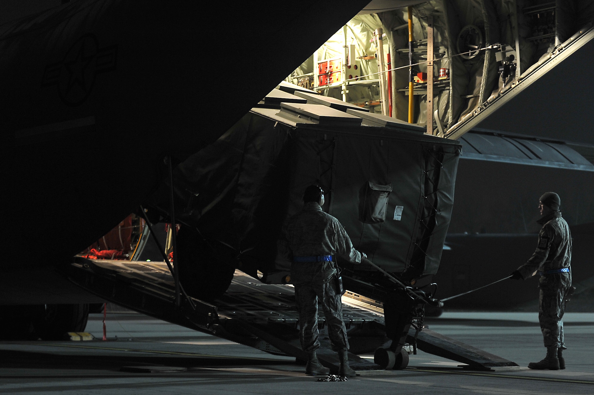 Members of the 86th Aircraft Maintenance Squadron and the 37th Airlift Squadron help load cargo onto a C-130J Super Hercules on the flightline at Ramstein Air Base, Germany, Jan. 7, 2013. The 86th Airlift Wing provides support to the NATO led coalition that will augment Turkey's air defense capabilities and contribute to the de-escalation of the crisis along the border. (U.S. Air Force photo/Airman 1st Class Holly Cook)