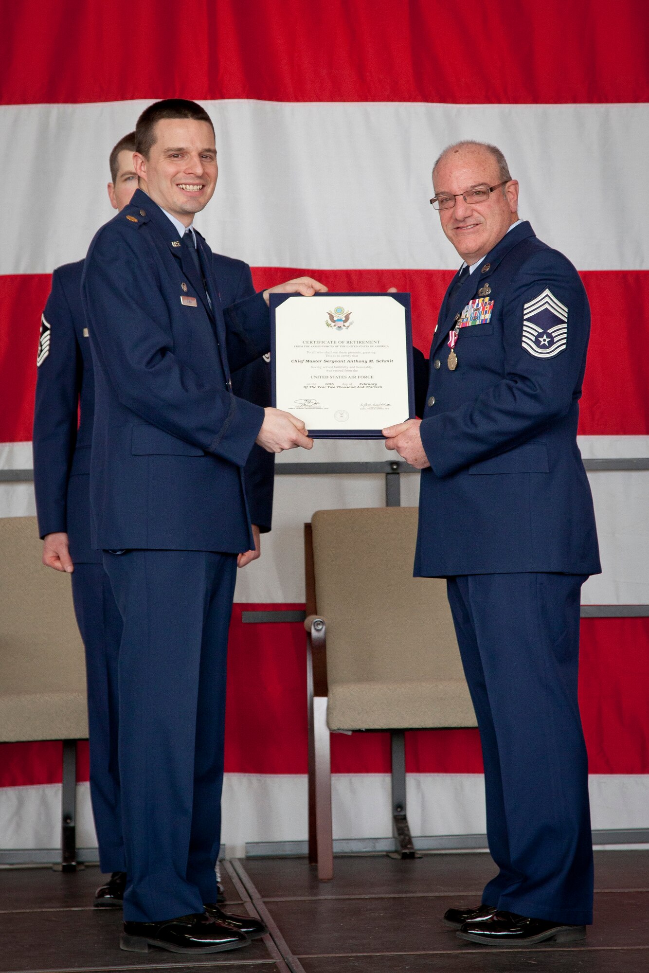 Maj. Andrew J. Staut, 934th Maintenance Squadron commander, presents Chief Master Sgt. Anthony M. Schmit, Maintenance Squadron superintendent, with his certificate of retirement. Schmit retires from the 934 MXS, Minneapolis-St. Paul Air Reserve Station, Minn., after 36 years of service.  (U.S. Air Force Photo/Shannon McKay)