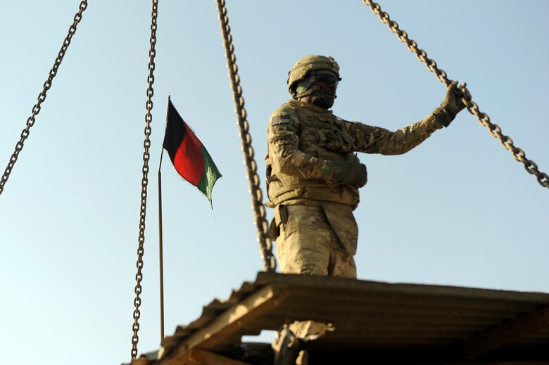 Army Sgt. Forrard McMillian, 857th Engineer Company, pauses to survey his team’s work, Jan. 6, 2013. Soldiers from the 857th Engineer Company partnered with 455th Expeditionary Security Forces Group Airmen and Afghan National Police to transfer an armored guard post from Bagram Airfield to local ANP forces for use near the base. (U.S. Air Force photo/Capt. Erika Yepsen)