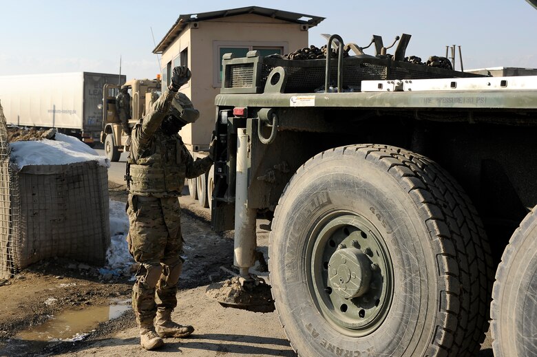 Army Spc. Michael McCree, 857th Engineer Company, guides a crane into place at an Afghan National Police checkpoint near Bagram Airfield, Jan. 6, 2013. Soldiers from the 857th Engineer Company partnered with 455th Expeditionary Security Forces Group Airmen and Afghan National Police to transfer an armored guard post from Bagram Airfield to local ANP forces for use near the base. (U.S. Air Force photo/Capt. Erika Yepsen)