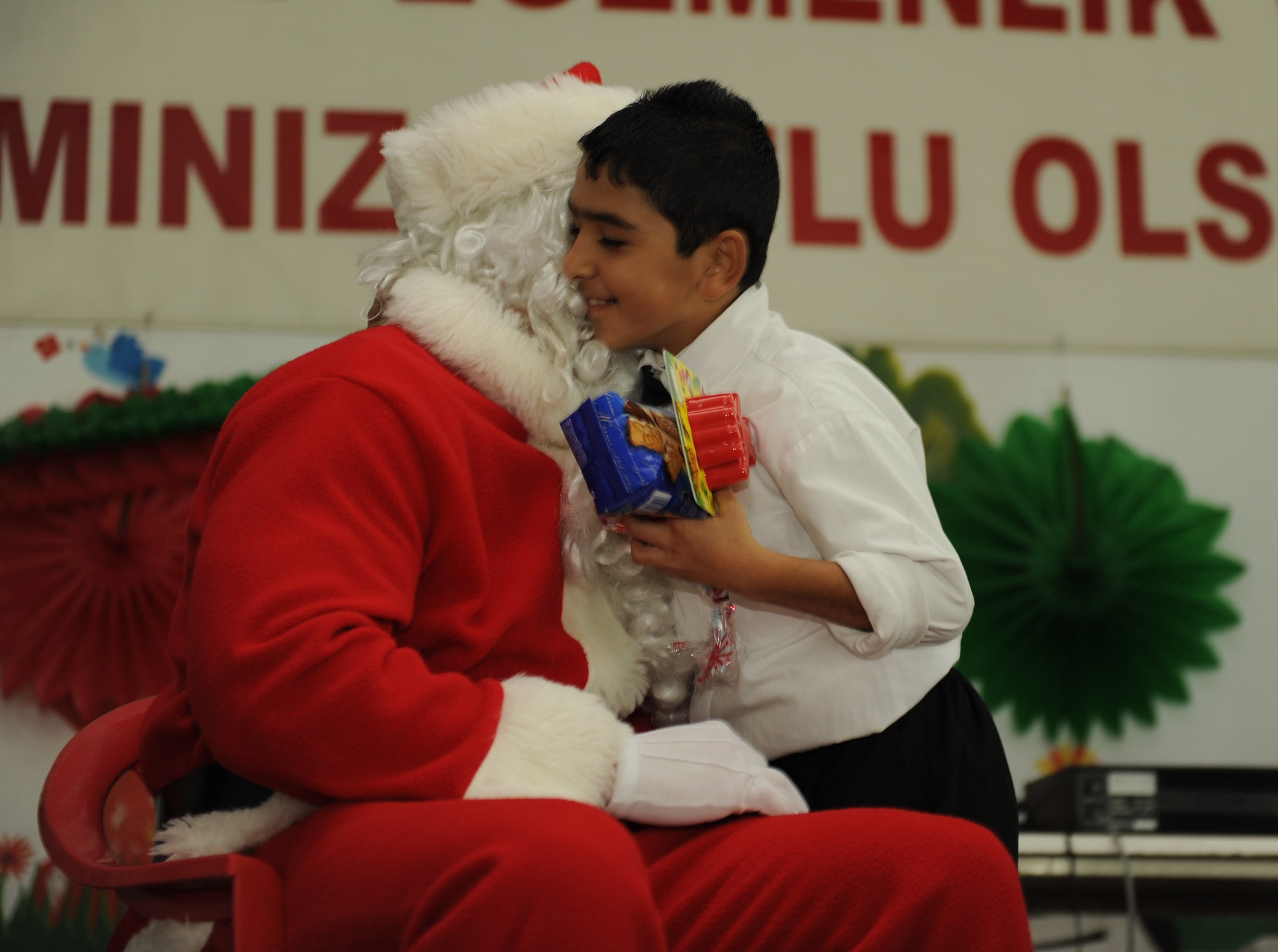 A child gives a hug to St. Nicholas, or Noel Baba as he is known in Turkey, during a New Year’s celebration at the Seyhan Isitme Engelliler Ilkogretim Okulu (Seyhan Hearing Impaired Primary School) Dec. 27, 2012, in Adana, Turkey. Members of the 90th Expeditionary Air Refueling Squadron threw a party for the children at the school as part of an ongoing tradition at Incirlik. (U.S. Air Force photo by Staff Sgt. Marissa Tucker/Released)