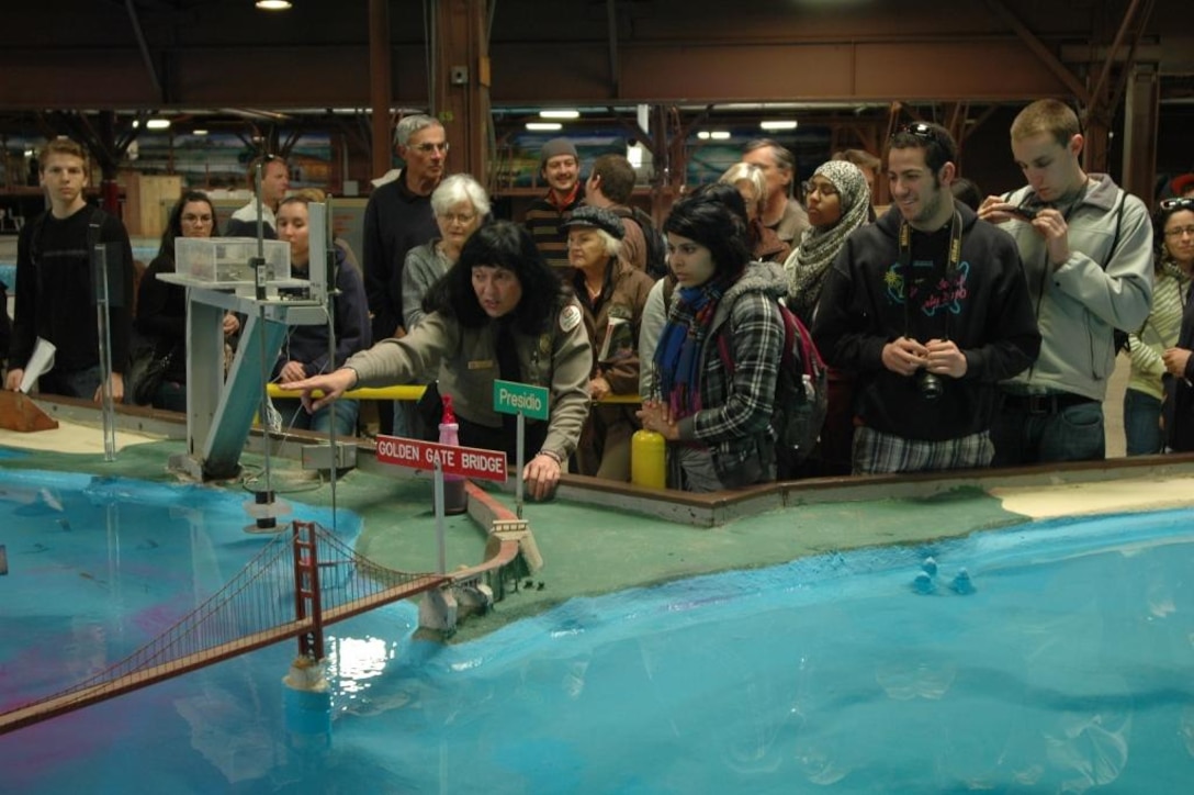Linda Holm, middle, park ranger at the Bay Model Visitor Center, leads a group of visitors through the Bay Model during a public reopening ceremony Feb. 25.