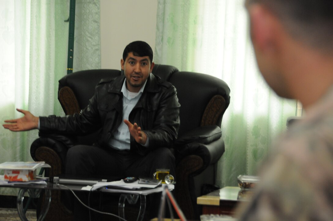 Abdul Manan Matin, Farah provincial director of agriculture, irrigation and livestock, talks with U.S. Army Capt. Gebhart, a civil affairs officer with Provincial Reconstruction Team Farah, during a meeting in Matin's office in Farah City, Afghanistan, Jan. 8, 2013. 