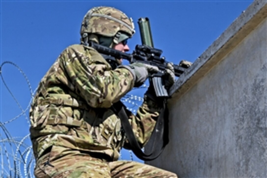 A U.S. soldier provides security along a wall on Combat Out Post Baraki-Barak in Afghanistan's Logar province, Jan. 5, 2013. The soldier is assigned to the 1st Squadron, 91st Calvary Regiment, 173rd Airborne Brigade Combat Team.