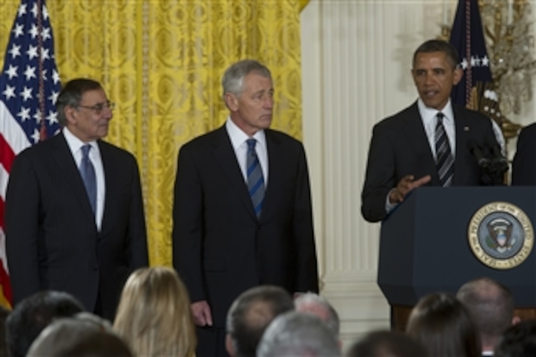Secretary of Defense Leon E. Panetta, left, and former Sen. Chuck Hagel, center, listen as President Barack Obama addresses the audience at the nomination announcement for Hagel as the next secretary of defense in the East Room of the White House on Jan. 7, 2013.  