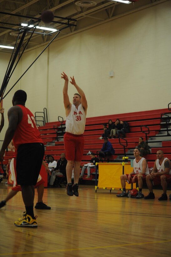 Josh Buchholz, head coach, Marine Corps Intelligence Activities, takes a jump shot during the first intramural basketball game of the season against Enlistment Incentive Program at the Barber Physical Fitness Center on Monday. Buchholz led his to their first victory of the season, 42-22. 