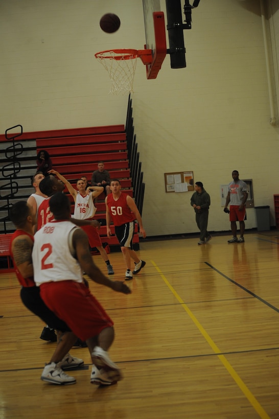 Robert Shortway, player, Marine Corps Intelligence Activities intramural basketball team, takes a 3-point shot during the first game of the season against Enlistment Incentive Program, at the Barber Physical Fitness Center on Monday. MCIA had a steady lead in the first half and held on to it, winning, 42-22. 