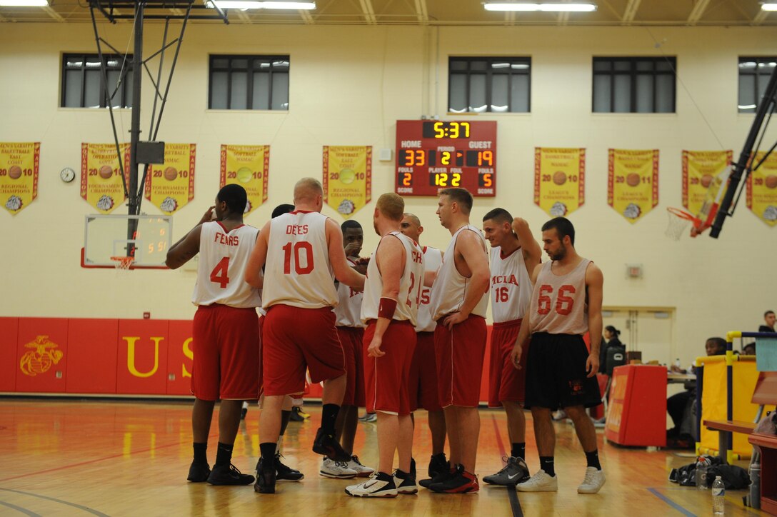 Marine Corps Intelligence Activities intramural basketball team huddles together during a timeout at the first game of the season at Barber Physical Fitness Center on Monday. MCIA faced off against Enlistment Incentive Program’s intramural basketball team for the 42-22 win. 