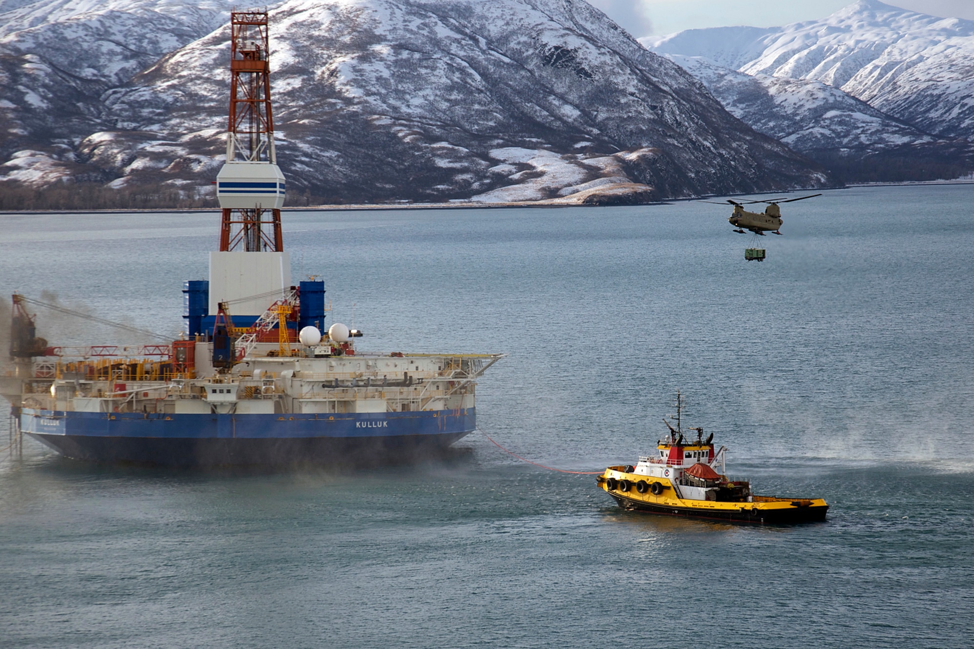 A CH-47F Chinook helicopter piloted by Chief Warrant Officer 3 Tommi Weber and Chief Warrant Officer 3 Chris Hastings, and crewed by Sgt. 1st Class Clayton Sauer and Sgt. Michael Cummings carries a 16,000-pound load to the stranded oil rig Kulluk Jan. 7. Two CH-47F Chinook helicopters from B Company, 1st Battalion, 52nd Aviation Regiment flew to Kodiak on a mission to help the Kulluk by hauling equipment to and from the rig. (U.S. Air Force photo/SSgt. Aaron M. Johnson)