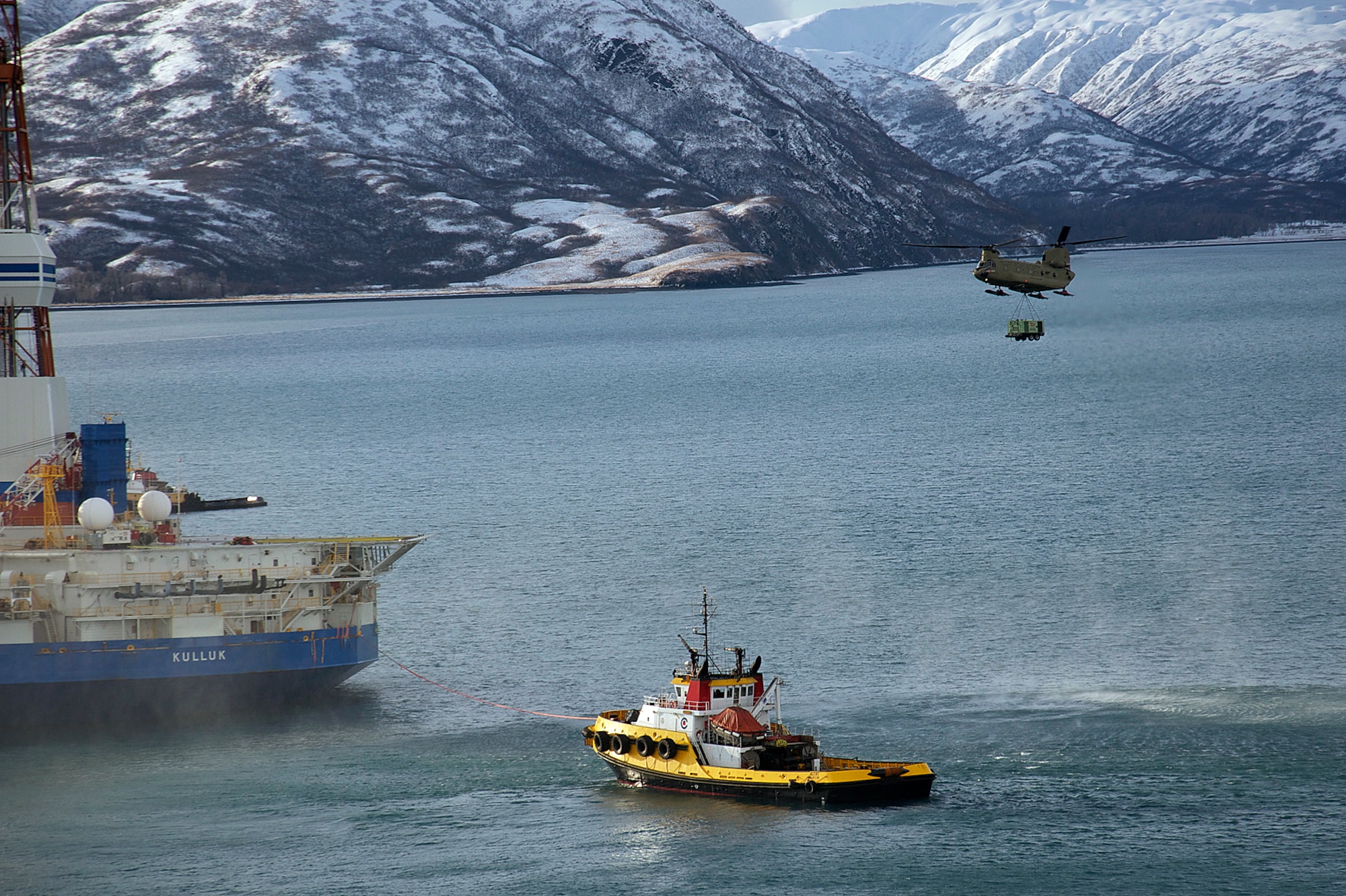 A CH-47F Chinook helicopter piloted by Chief Warrant Officer 3 Tommi Weber and Chief Warrant Officer 3 Chris Hastings, and crewed by Sgt. 1st Class Clayton Sauer and Sgt. Michael Cummings carries a 16,000-pound load to the stranded oil rig Kulluk Jan. 7. Two CH-47F Chinook helicopters from B Company, 1st Battalion, 52nd Aviation Regiment flew to Kodiak on a mission to help the Kulluk by hauling equipment to and from the rig. (U.S. Air Force photo/SSgt. Aaron M. Johnson)