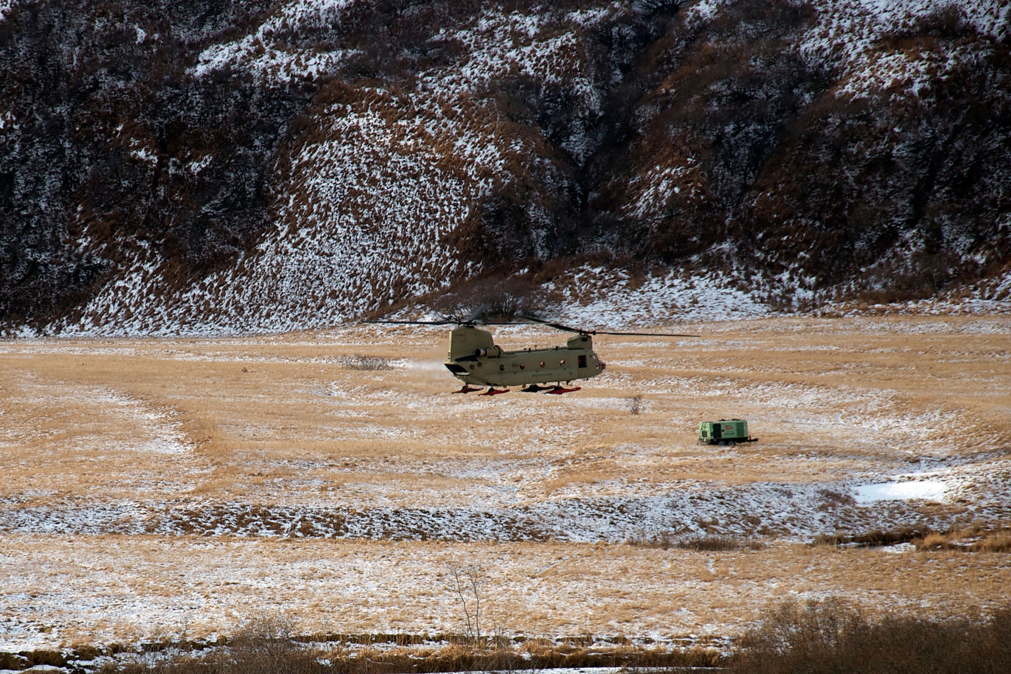 A CH-47F Chinook helicopter piloted by Chief Warrant Officer 3 Tommi Weber and Chief Warrant Officer 3 Chris Hastings, and crewed by Sgt. 1st Class Clayton Sauer and Sgt. Michael Cummings picks up a 16,000-pound load Jan. 7. Two CH-47F Chinook helicopters from B Company, 1st Battalion, 52nd Aviation Regiment flew to Kodiak on a mission to help the grounded oil rig Kulluk by hauling equipment to and from the rig. (U.S. Air Force photo/SSgt. Aaron M. Johnson)