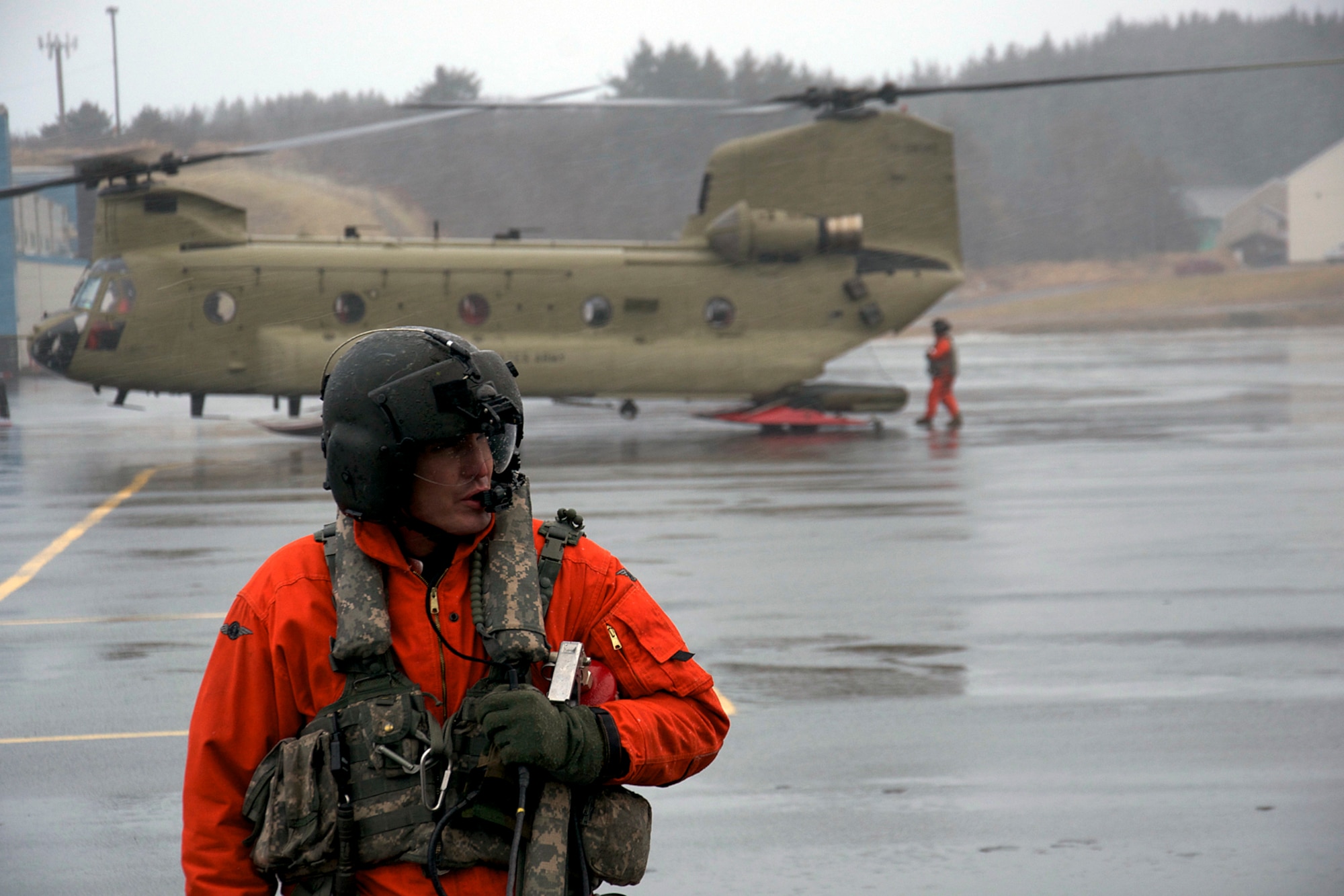 Army Staff Sgt. Evan Sutton waits as his CH-47F helicopter is refueled Jan. 7. Two CH-47F Chinook helicopters from B Company, 1st Battalion, 52nd Aviation Regiment flew to Kodiak on a mission to help the grounded oil rig Kulluk by hauling equipment to and from the rig. (U.S. Air Force photo/SSgt. Aaron M. Johnson)