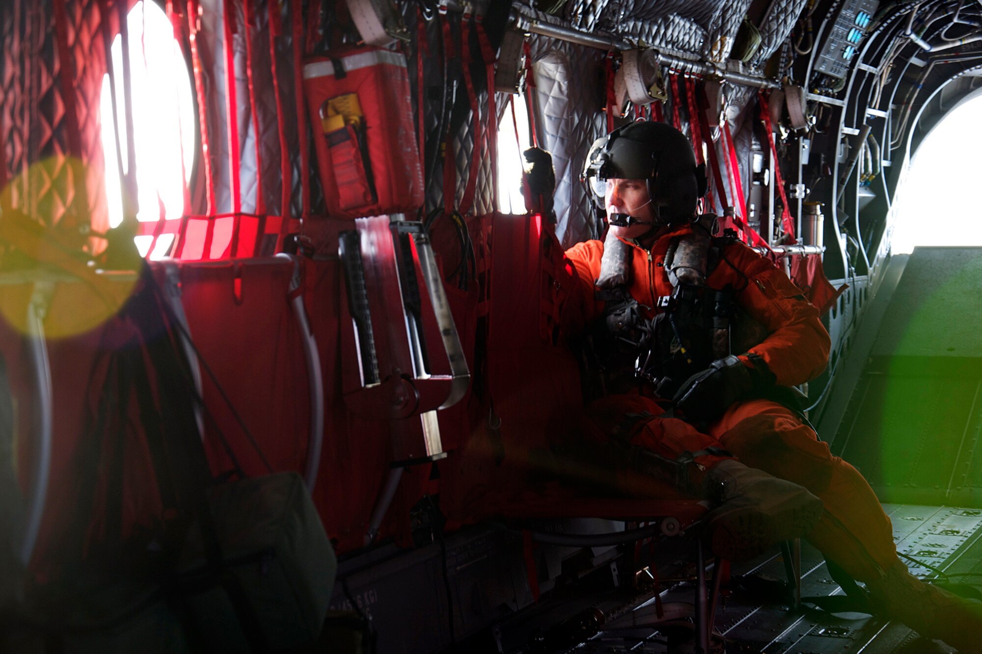 Army Staff Sgt. Evan Sutton watches out a side window for potential hazards as his CH-47F helicopter flies toward the Kodiak coast Jan. 7. Two CH-47F Chinook helicopters from B Company, 1st Battalion, 52nd Aviation Regiment flew to Kodiak on a mission to help the grounded oil rig Kulluk by hauling equipment to and from the rig. (U.S. Air Force photo/SSgt. Aaron M. Johnson)