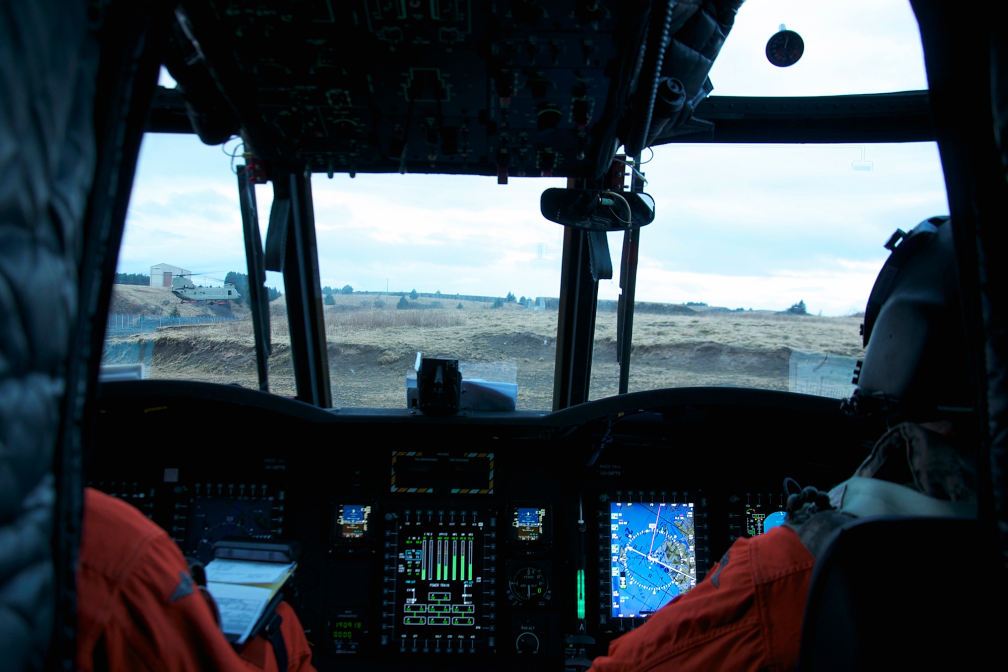 Capt. Matt Mraz (left) and Chief Warrant Officer 3 Herman Evans fly one of the two CH-47F Chinook helicopters from B Company, 1st Battalion, 52nd Aviation Regiment. The two helicopters and crews flew to Kodiak on a mission to help the grounded oil rig Kulluk by hauling equipment to and from the rig. (U.S. Air Force photo/SSgt. Aaron M. Johnson)