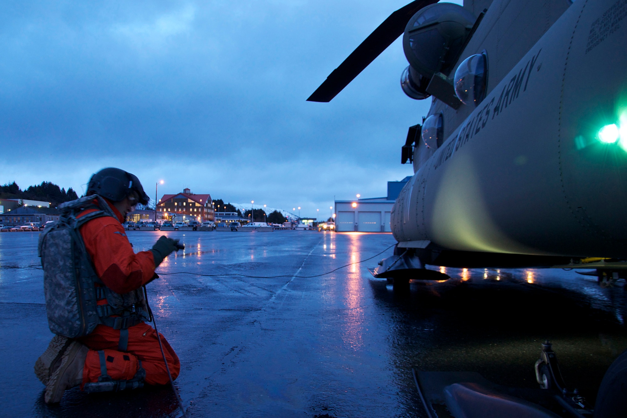 Sgt. Anthony Phillips does pre-flight checks on his CH-47F Chinook helicopter Jan. 7. Phillips is a crew member for one of the two CH-47F Chinook helicopters from B Company, 1st Battalion, 52nd Aviation Regiment that flew to Kodiak on a mission to help the grounded oil rig Kulluk by hauling equipment to and from the rig. (U.S. Air Force photo/SSgt. Aaron M. Johnson)