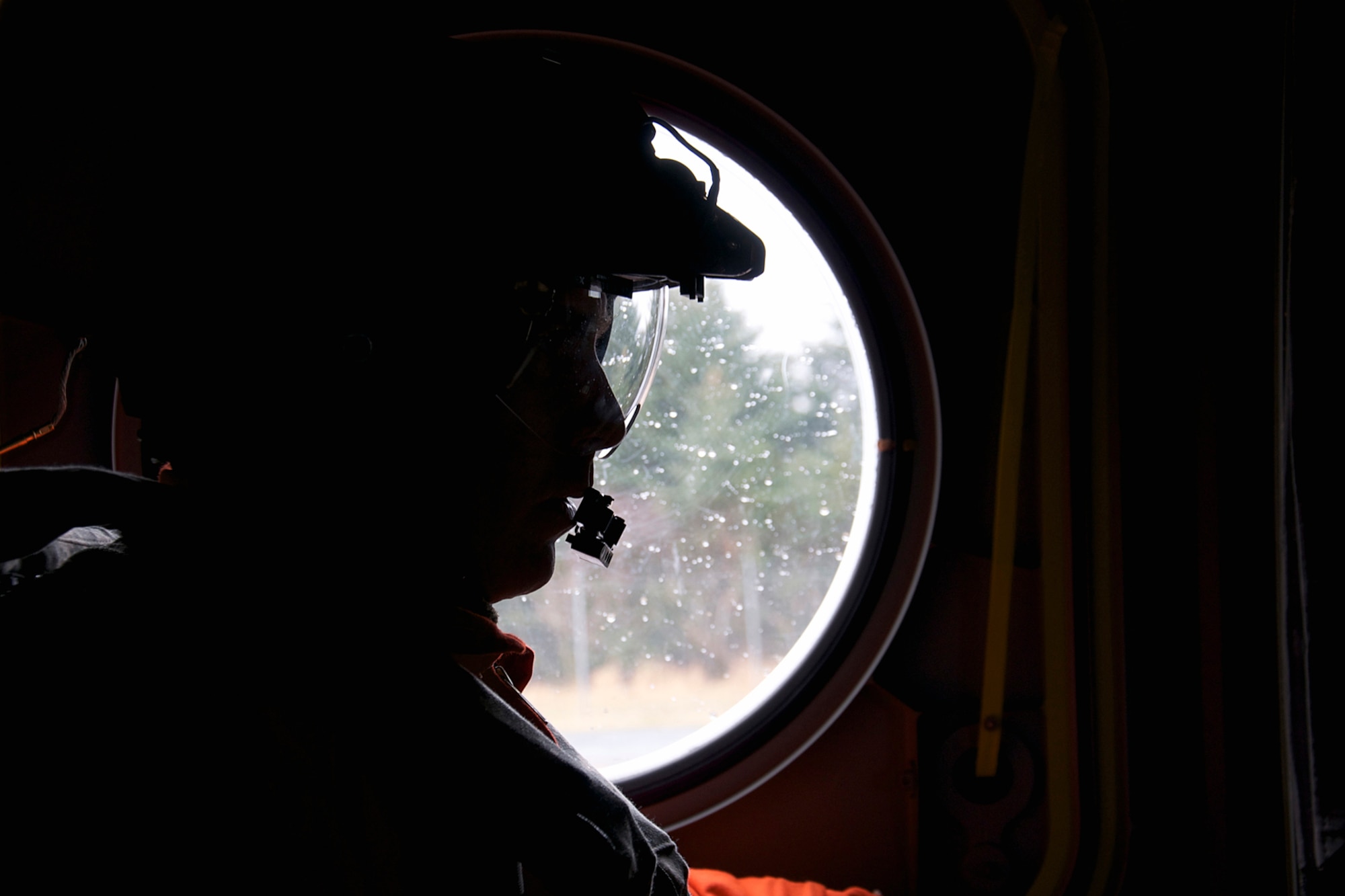 Army Staff Sgt. Evan Sutton checks for clearance on the side of the aircraft before takeoff Jan.5. Sutton is a crew member on one of the two CH-47F Chinook helicopters from B Company, 1st Battalion, 52nd Aviation Regiment that flew to Kodiak on a mission to help the grounded oil rig Kulluk by hauling equipment to and from the rig. (U.S. Air Force photo/Staff Sgt. Aaron M. Johnson)