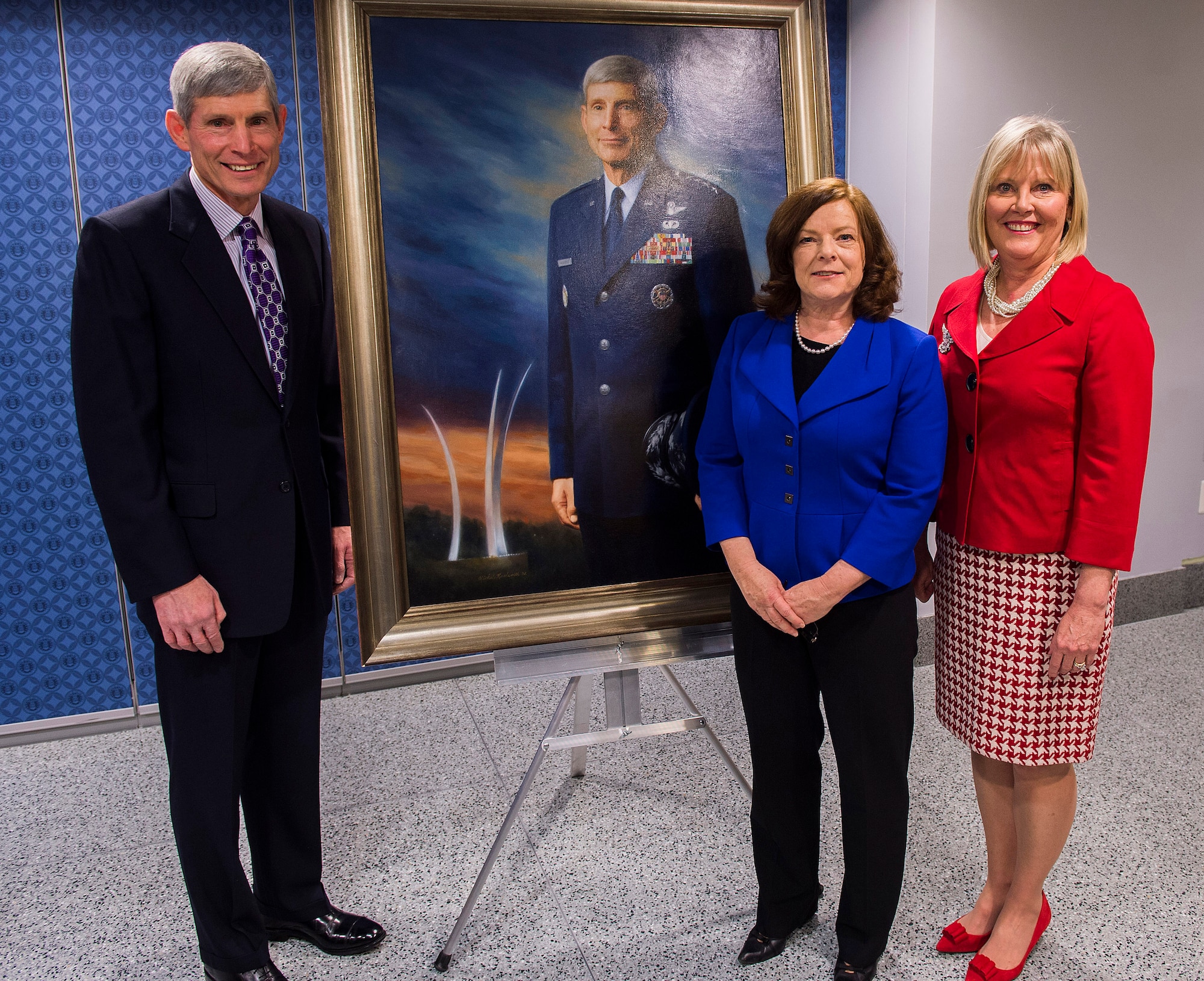 Retired Gen. Norton Schwartz, artist Michele Rushworth, and Mrs. Suzie Schwartz pose with the official portrait of the former Air Force chief of staff following its unveiling in the Pentagon, Washington, D.C., on Jan. 8, 2013. The portrait will be on display in the Pentagon's Arnold Corridor. (U.S. Air Force photo/Jim Varhegyi)