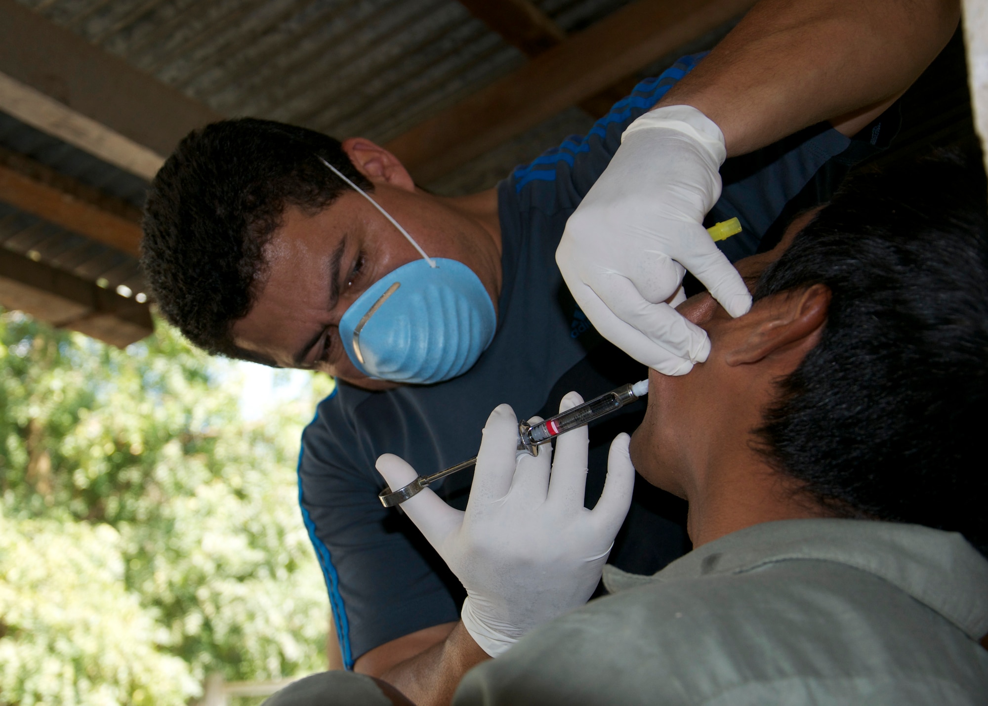 Dr. Wilmer Amador, JTF-B Dentist, gives a patient a shot before his tooth is extracted during a four-day joint medical readiness training exercise Dec. 11. The service members from Joint Task Force-Bravo with assistance from the United States Embassy in Guatemala, the Guatemala Ministry of Health and the Guatemalan Army saw more than 500 patients a day during the MEDRETE. (U.S. Air Force photo/Staff Sgt. Eric Donner)