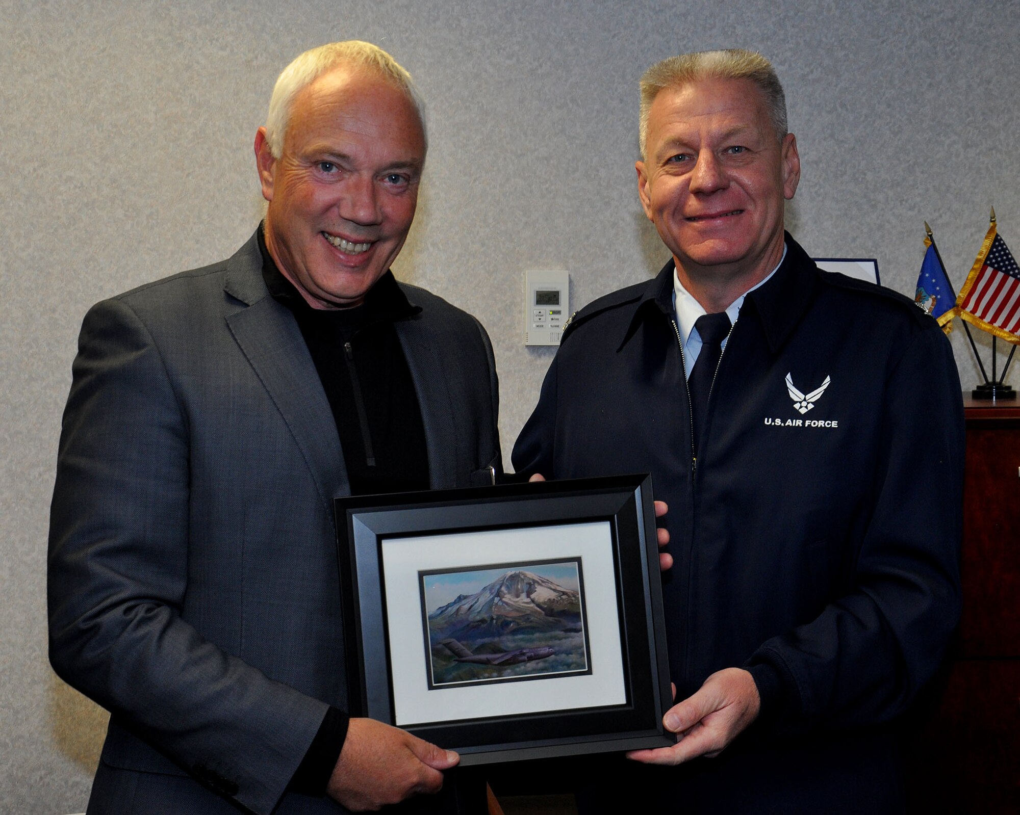 Col. Bruce Bowers, Reserve commander of the 446th Airlift Wing, presents a gift to Mayor Bob Parker of Christchurch, New Zealand Jan. 9. The gift was given as gratitude for the mayor's support of Operation Deep Freeze. Christchurch International Airport is the staging point for C-17 operations to Antarctica in support in Operation Deep Freeze. The National Science Foundation manages the United States Antarctic Program which conducts scientific research in the frozen climate. Operation Deep Freeze supports the program by sending C-17s carrying fuel, supplies, and people to the continent. McChord's 446th AW and 62nd Airlift Wing together have transported more than 40,000 passengers and 45 million pounds of cargo since the first mission with the C-17 in 1999. (U.S. Air Force Photo/Airman 1st Class Madelyn McCullough)