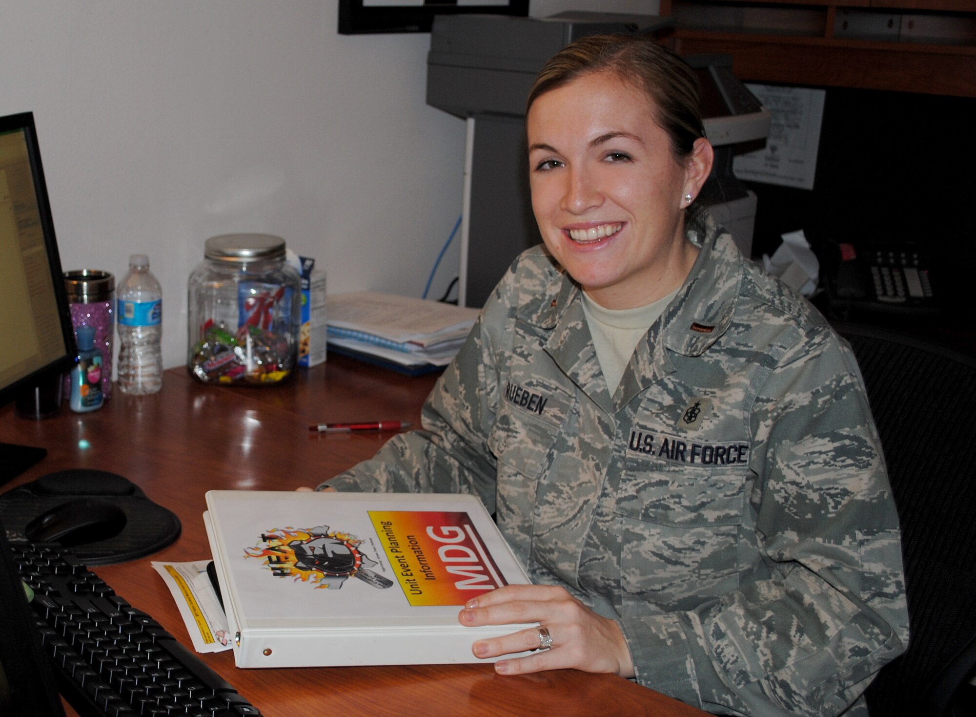 2nd Lt. Charlene Rueben, 319th Medical Group practice manager, smiles for a photo at her office Jan. 9, 2013, at the medical clinic on Grand Forks Air Force Base, N.D. Rueben also serves as the unit’s group patient advocate. She served eight years as a public health technician prior to her officer commission. (U.S. Air Force photo/Senior Airman Luis Loza Gutierrez)
