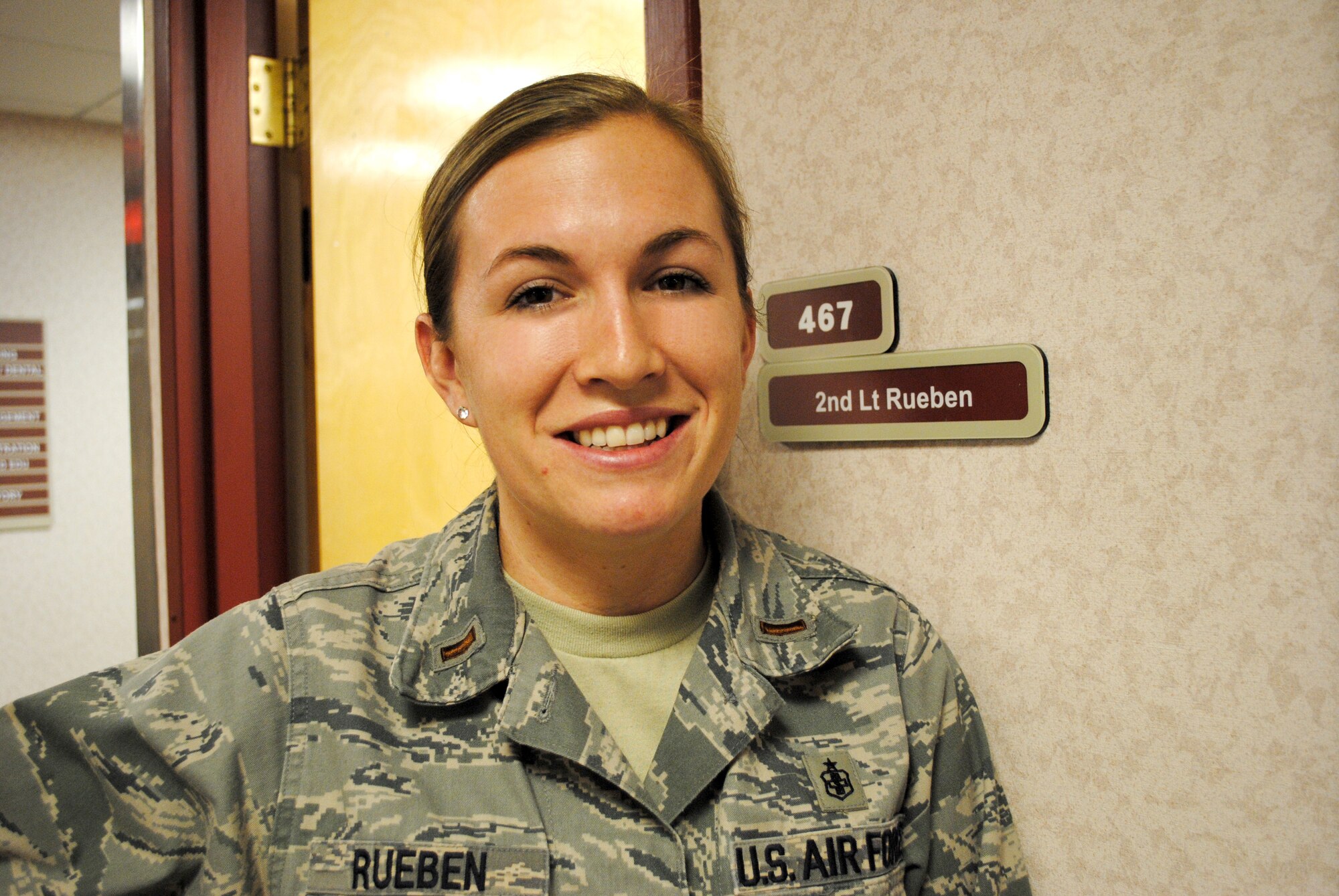 2nd Lt. Charlene Rueben, 319th Medical Group practice manager, smiles for a photo outside her office Jan. 9, 2013, at the medical clinic on Grand Forks Air Force Base, N.D. Rueben also serves as the executive officer for the commander of the 319th MDG, Col. Jane Denton. Rueben said Denton is a wonderful leader and mentor, and has taught her things she will use for the rest of her career. (U.S. Air Force photo/Senior Airman Luis Loza Gutierrez)