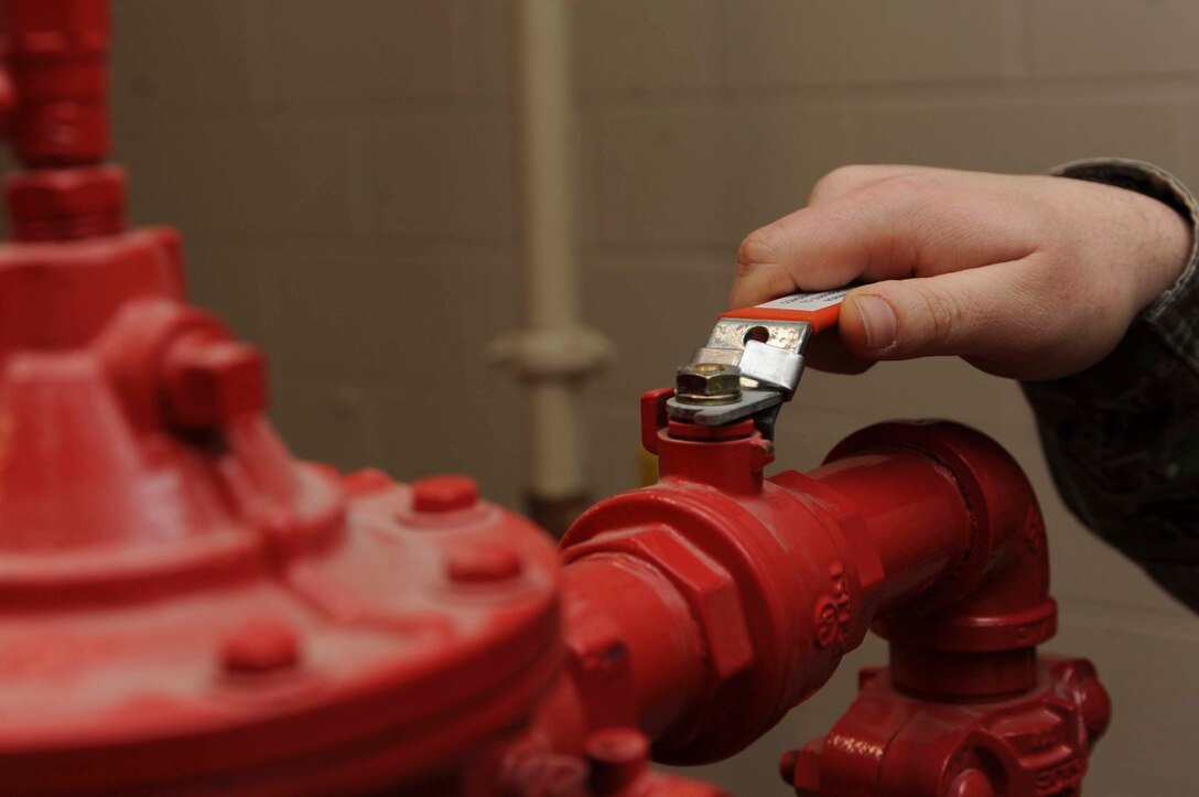 Staff Sgt. David Overstreet, 28th Civil Engineer Squadron water fuels systems maintenance, checks proper pressure levels on a high expansion foam system at the Petroleum Oil Liquids Control Facility on Ellsworth Air Force Base, S.D., Dec. 19, 2012. Monthly maintenance checks to the system ensure proper operation in the event an emergency. (U.S. Air Force photo by Airman 1st Class Anania Tekurio/Released)