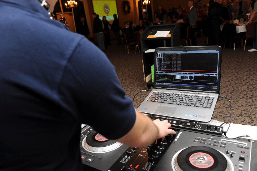 Staff Sgt. David Overstreet, 28th Civil Engineer Squadron water fuels systems maintenance, chooses specific songs to play during the 28th CES Christmas party at the Dakota’s Club on Ellsworth Air Force Base, S.D., Dec. 14, 2012. Also known as DJ “Street,” Overstreet has disc jockeyed for several events since his return from a recent deployment. (U.S. Air Force photo by Airman 1st Class Anania Tekurio/Released)