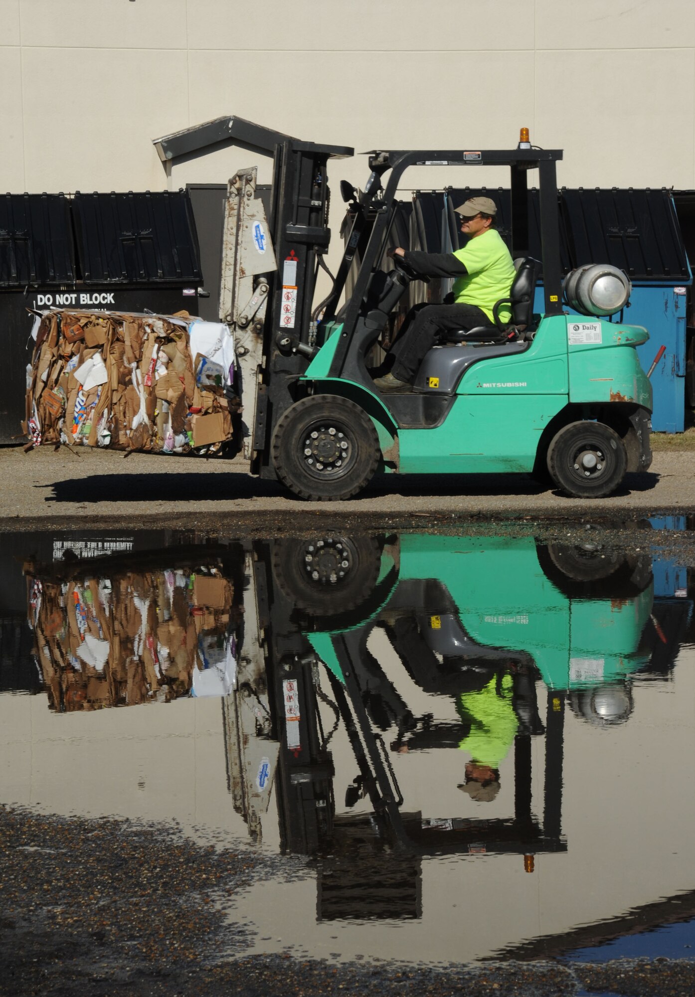 Shane Olsen, recycling center contractor, uses a forklift to carry a bail of flattened cardboard boxes to be recycled. Keesler’s recycling center recently won the Environmental Hero Award, Recycler of the Year in the state and federal government category from the Mississippi Recycling Coalition. In fiscal year 2012, the center recycled 2,383 tons of materials including 323.45 tons of food waste, a unique effort in south Mississippi. This effort saved $99,555.44 from going to landfills and resulted in $180,119 of revenue being returned to the base. (U.S. Air Force photo by Kemberly Groue