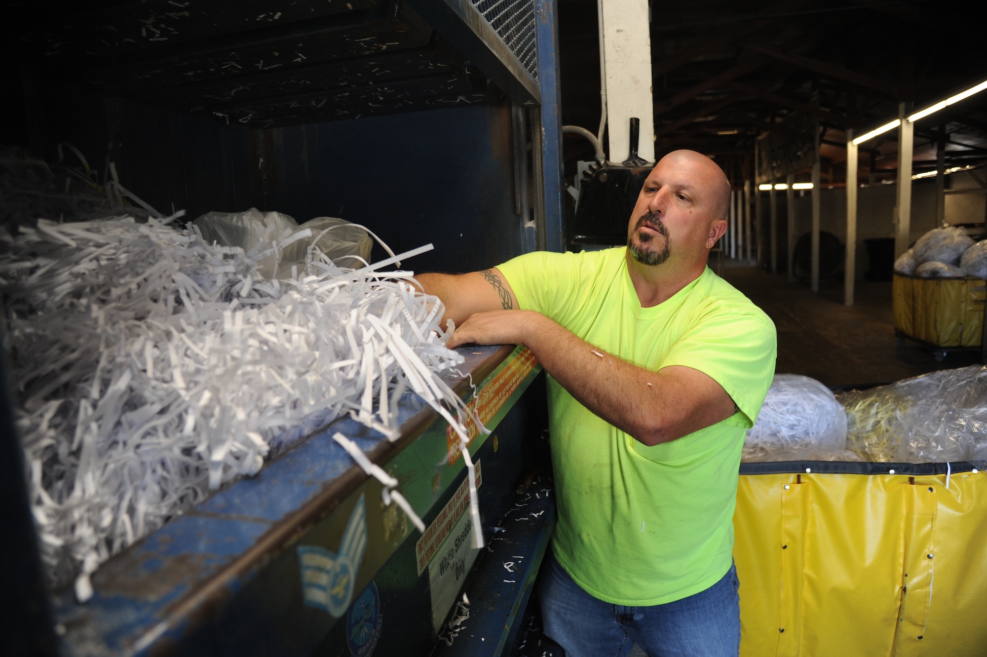 Duane Olsen, recycling center contractor, empties a bag of shredded paper into a bailing machine. Keesler’s recycling center recently won the Environmental Hero Award, Recycler of the Year in the state and federal government category from the Mississippi Recycling Coalition. In fiscal year 2012, the center recycled 2,383 tons of materials including 323.45 tons of food waste, a unique effort in south Mississippi. This effort saved $99,555.44 from going to landfills and resulted in $180,119 of revenue being returned to the base. (U.S. Air Force photo by Kemberly Groue