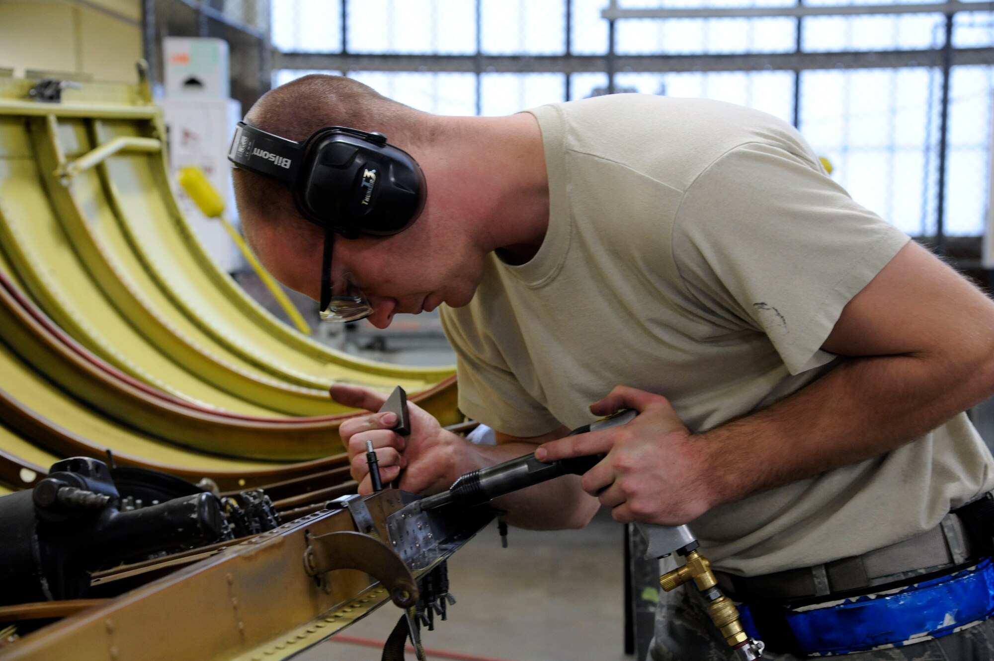 Staff Sgt. Matthew Bosworth, 2nd Maintenance Squadron fabrication flight, shoots rivets into a B-52H Stratofortress bomber's engine cowling after repairing a crack on Barksdale Air Force Base, La., Jan. 9. Regular maintenance ensures Barksdale's B-52s remain in the air. (U.S. Air Force photo/Airman 1st Class Andrew Moua)