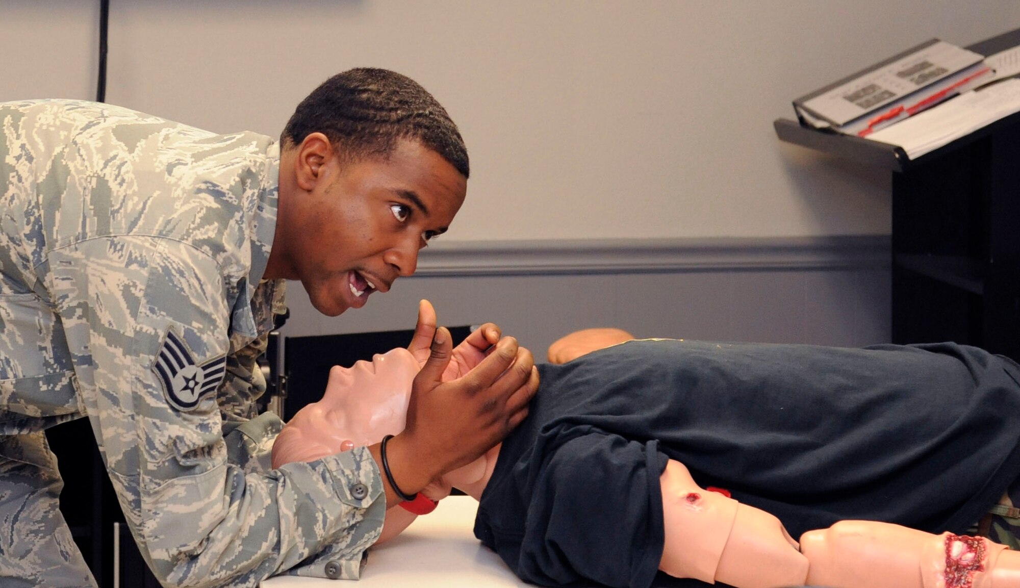 Staff Sgt. Gary Chappell, 2nd Maintenance Operations Squadron Maintenance Training Instructor, demonstrates the proper way to open and maintain an airway during a Self Aid and Buddy Care class on Barksdale Air Force Base, La., Jan. 8. SABC teaches basic life-support techniques to help injured personnel survive until medical help arrives. (U.S. Air Force photo/Airman 1st Class Andrew Moua)