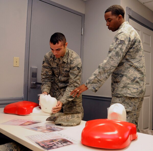 Senior Airman Justin Velez, 2nd Maintenance Squadron, performs CPR on a training dummy during Self Aid and Buddy Care training as Staff Sgt. Gary Chappell, 2nd Maintenance Operations Squadron Maintenance Training Instructor, gives directions on proper technique on Barksdale Air Force Base, La., Jan. 8. SABC teaches basic life-support techniques to help injured personnel survive until medical help arrives. (U.S. Air Force photo/Airman 1st Class Andrew Moua)
