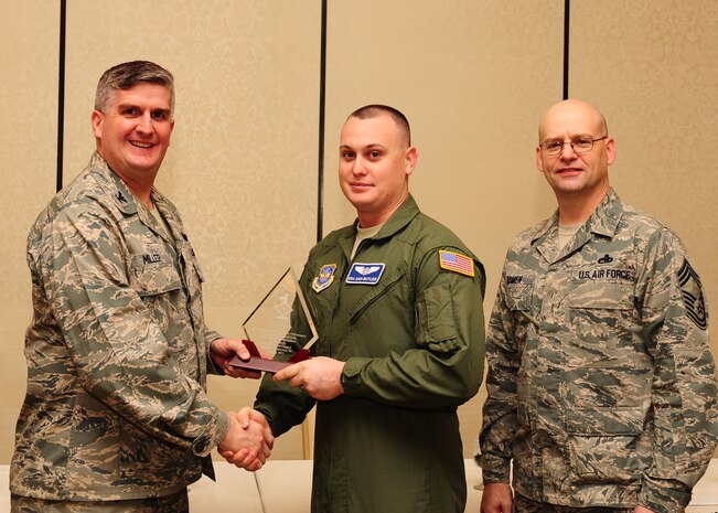 Col. Al Miller, 437th Airlift Wing vice commander, and Chief Master Sgt. Gerard Komen, 437th Maintenance Operations Squadron superintendent, present the Diamond Sharp award to Senior Airman Daniel Butler, 17th Airlift Squadron loadmaster Jan. 8, 2013, at Joint Base Charleston - Air Base, S.C. The Diamond Sharp awards recognize individuals in a unit who stand out to their first sergeant. (U.S. Air Force photo/ Airman 1st Class Chacarra Walker)