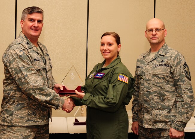 Col. Al Miller, 437th Airlift Wing vice commander, and Chief Master Sgt. Gerard Komen, 437th Maintenance Operations Squadron superintendent, present the Diamond Sharp award to Senior Airman Brandi Lopez, 15th Airlift Squadron loadmaster, Jan. 8, 2013, at Joint Base Charleston - Air Base, S.C. The Diamond Sharp awards recognize individuals in a unit who stand out to their first sergeant. (U.S. Air Force photo/ Airman 1st Class Chacarra Walker)