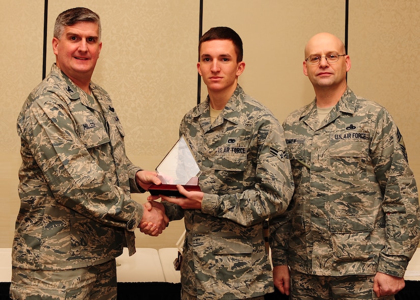 Col. Al Miller, 437th Airlift Wing vice commander, and Chief Master Sgt. Gerard Komen, 437th Maintenance Operations Squadron superintendent, present the Diamond Sharp award to Airman 1st Class Jared Cornell, 437th Aircraft Maintenance Squadron aerospace maintenance journeyman Jan. 8, 2013, at Joint Base Charleston - Air Base, S.C. The Diamond Sharp awards recognize individuals in a unit who stand out to their first sergeant. (U.S. Air Force photo/ Airman 1st Class Chacarra Walker)