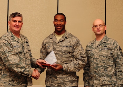 Col. Al Miller, 437th Airlift Wing vice commander, and Chief Master Sgt. Gerard Komen, 437th Maintenance Operations Squadron superintendent, present the Diamond Sharp award to Airman 1st Class Jonathan Levi, 437th Maintenance Squadron crew chief Jan. 8, 2013, at Joint Base Charleston - Air Base, S.C. The Diamond Sharp awards recognize individuals in a unit who stand out to their first sergeant. (U.S. Air Force photo/ Airman 1st Class Chacarra Walker)