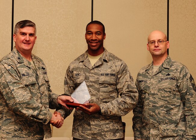 Col. Al Miller, 437th Airlift Wing vice commander, and Chief Master Sgt. Gerard Komen, 437th Maintenance Operations Squadron superintendent, present the Diamond Sharp award to Airman 1st Class Jonathan Levi, 437th Maintenance Squadron crew chief Jan. 8, 2013, at Joint Base Charleston - Air Base, S.C. The Diamond Sharp awards recognize individuals in a unit who stand out to their first sergeant. (U.S. Air Force photo/ Airman 1st Class Chacarra Walker)