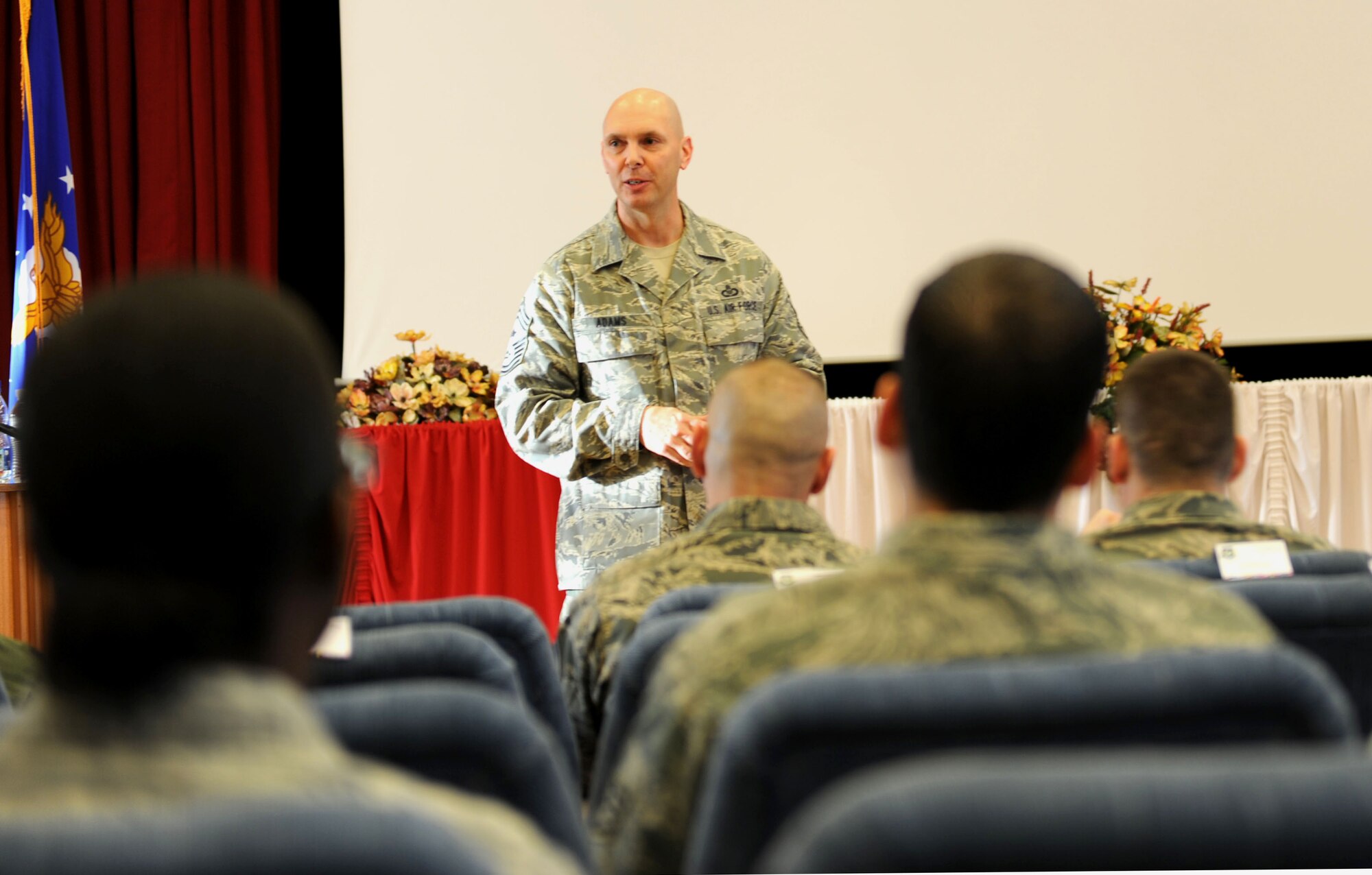 PAPA AIR BASE, Hungary -- Chief Master Sgt. Craig A. Adams, U.S. Air Forces in Europe and U.S. Air Forces Africa command chief, addresses a crowd of U.S. Airmen here during a base visit Jan. 7, 2013. The command chief thanked the Airmen for their contributions to the Heavy Airlift Wing. The chief visited the base to meet with the multi-national team and U.S. Airmen. U.S. AIr Force Photo by Capt. William Russell
