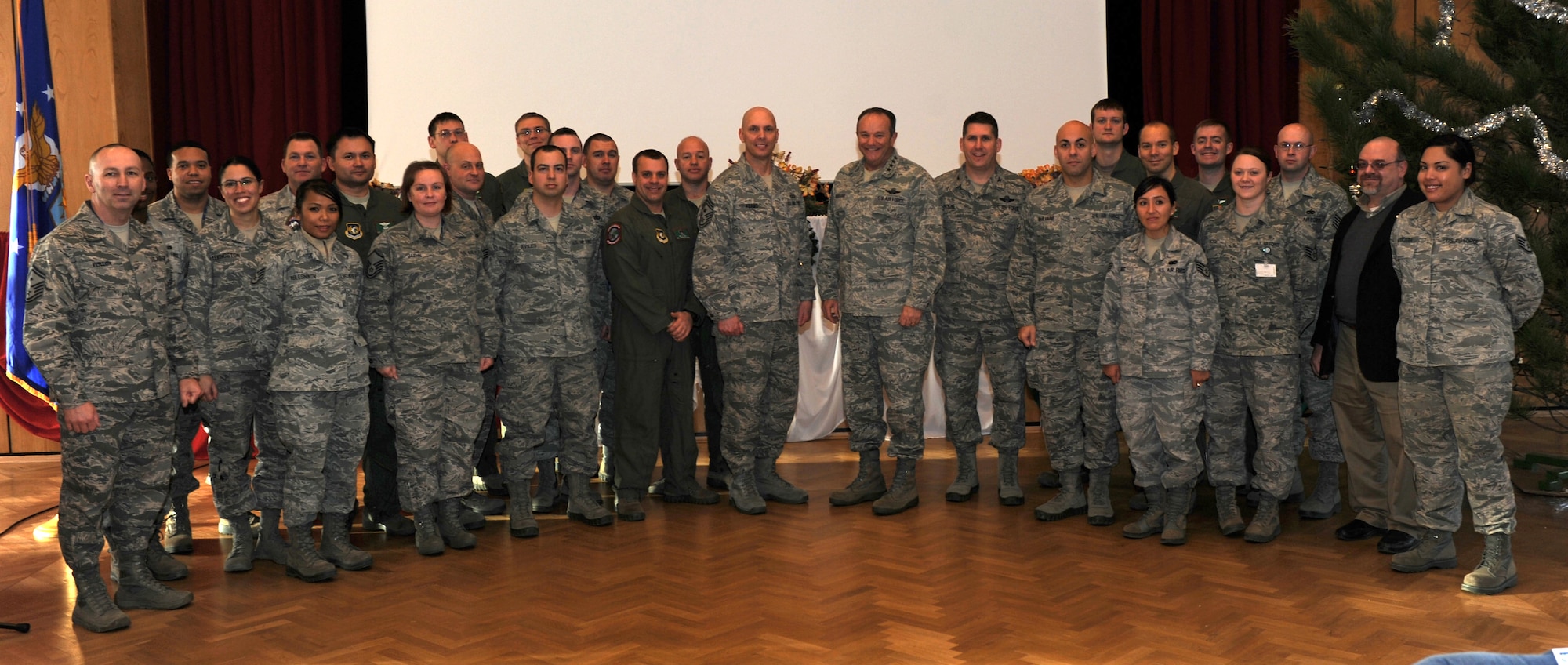 PAPA AIR BASE, Hungary -- Gen. Philip M. Breedlove, U.S. Air Forces in Europe and Air Forces Africa commander and Chief Master Sgt. Craig A. Adams, USAFE and AFAFRICA command chief, pose for a photo with several members of the Heavy Airlift Wing here Jan. 7, 2013. The general and command chief also hosted an “all call” with U.S. Airmen stationed here during the visit. U.S. AIr Force Photo by Capt. William Russell