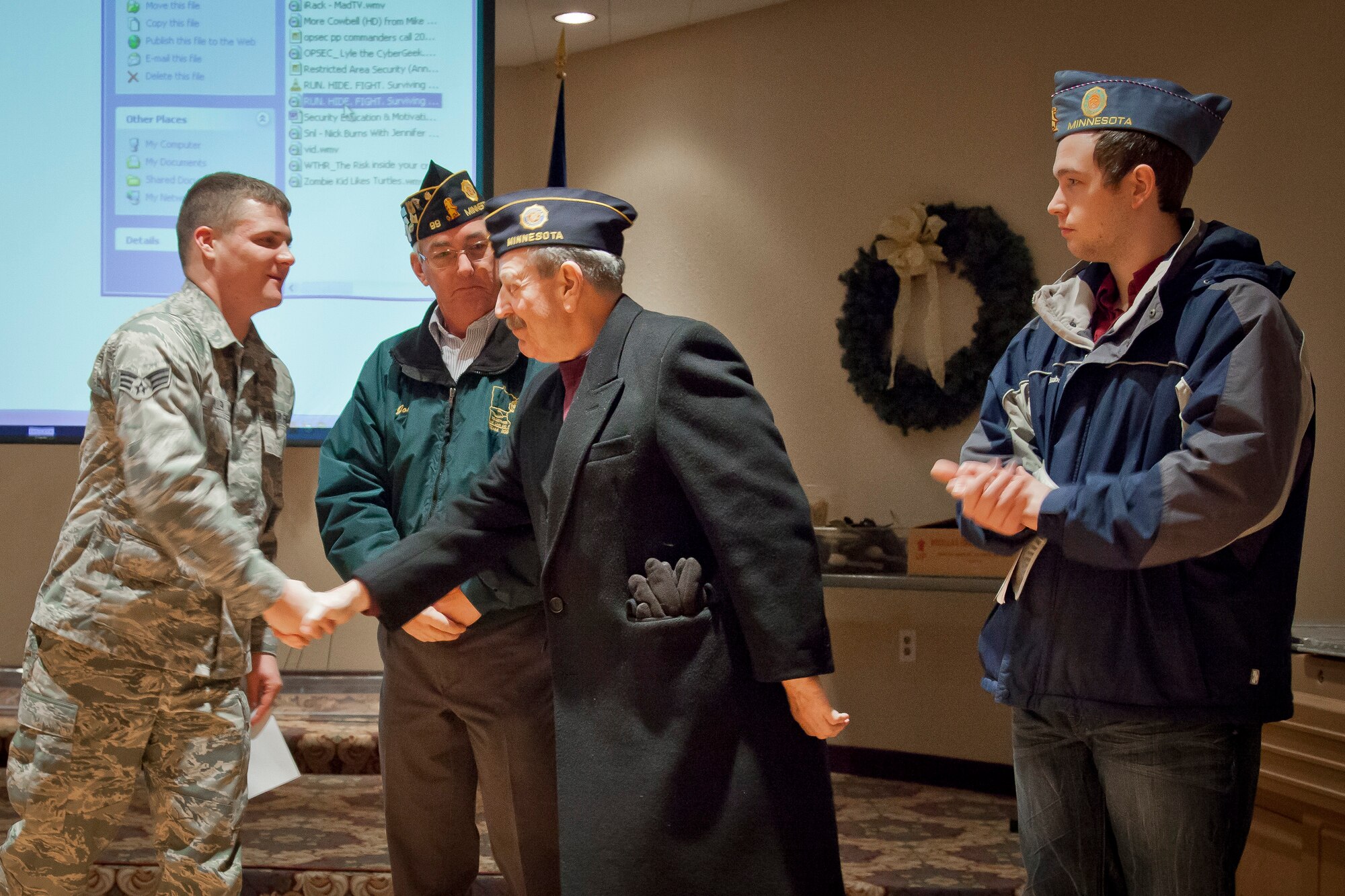 From American Legion Post #99, Commander Roger Fahrenkrug, Joe Bayer, and John Bayer recognize Senior Airman Zachary Allen, 27 Aerial Port Squadron for receiving the Legion's Certificate of Appreciation at the Minneapolis-St. Paul Air Reserve Station, Minn. (U.S. Air Force Photo/Shannon McKay)