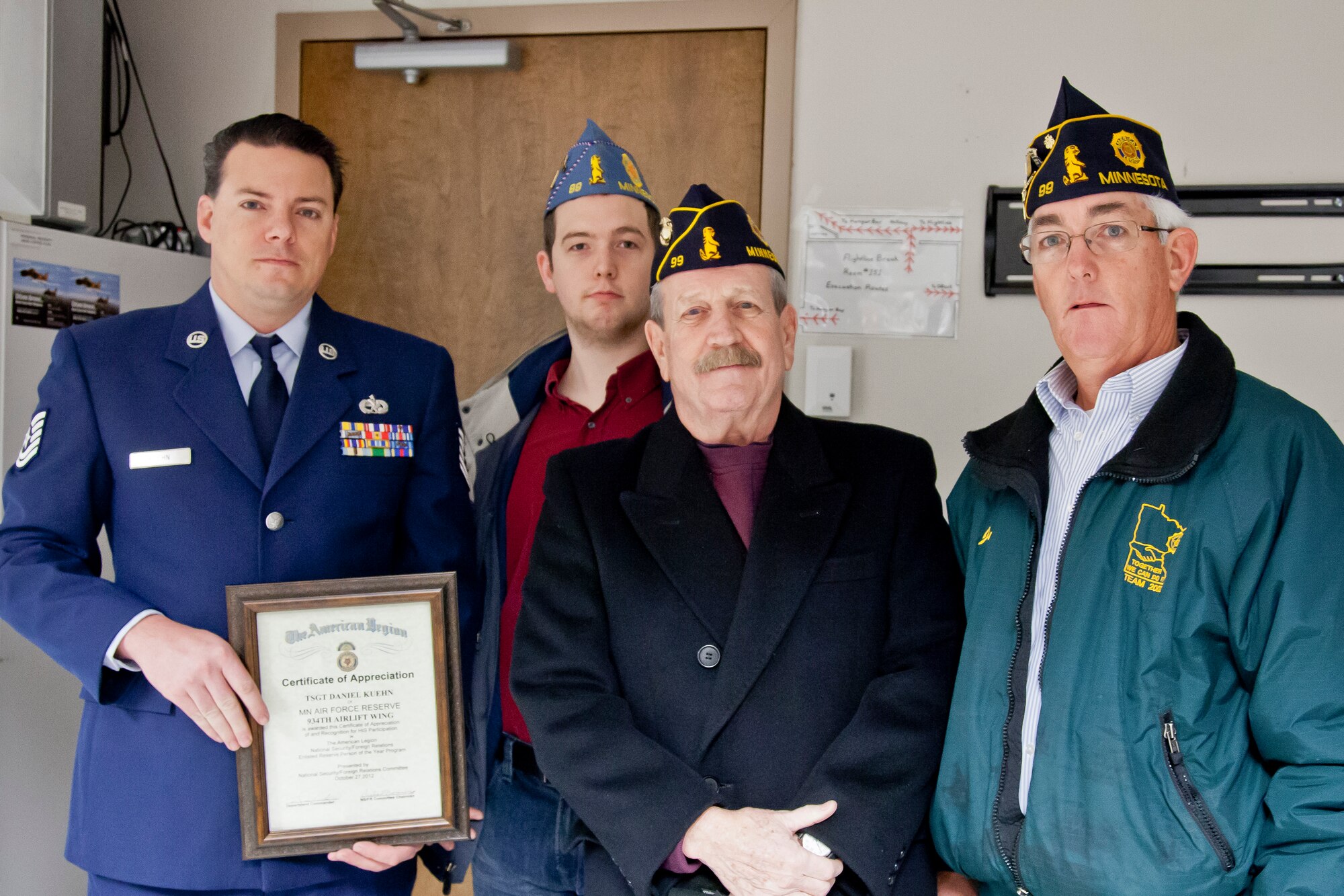 From American Legion Post #99, Commander Roger Fahrenkrug, Joe Bayer, and John Bayer present a Certificate of Appreciation to Tech. Sgt. Dan Kuehn, 934th Aircraft Maintenance Squadron at the Minneapolis-St. Paul Air Reserve Station, Minn. (U.S. Air Force Photo/Shannon McKay)