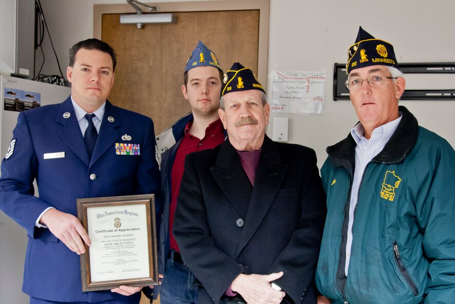 From American Legion Post #99, Commander Roger Fahrenkrug, Joe Bayer, and John Bayer present a Certificate of Appreciation to Tech. Sgt. Dan Kuehn, 934th Aircraft Maintenance Squadron at the Minneapolis-St. Paul Air Reserve Station, Minn. (U.S. Air Force Photo/Shannon McKay)