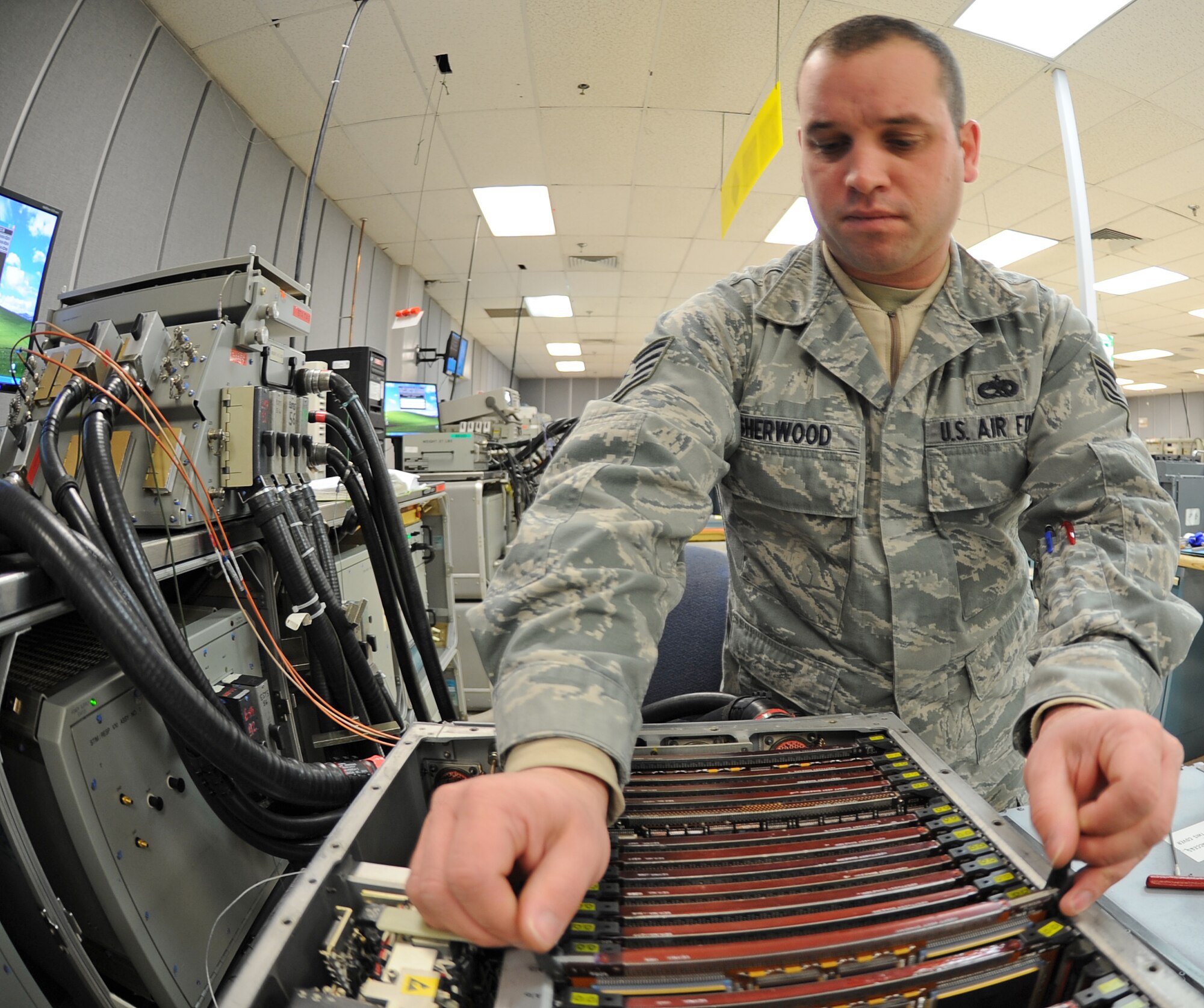U.S. Air Force Staff Sgt. Derrick Sherwood, 4th Component Maintenance Squadron intermediate avionics specialist, replaces a circuit card guard assembly on a digital radar signal processor on Seymour Johnson Air Force Base, N.C., Jan. 8, 2013. The digital radar signal processor is part of the F-15E Strike Eagle radar system what enables aircrew with the ability to detect air and ground targets. (U.S. Air Force photo/Airman 1st Class Gino Reyes/Released)