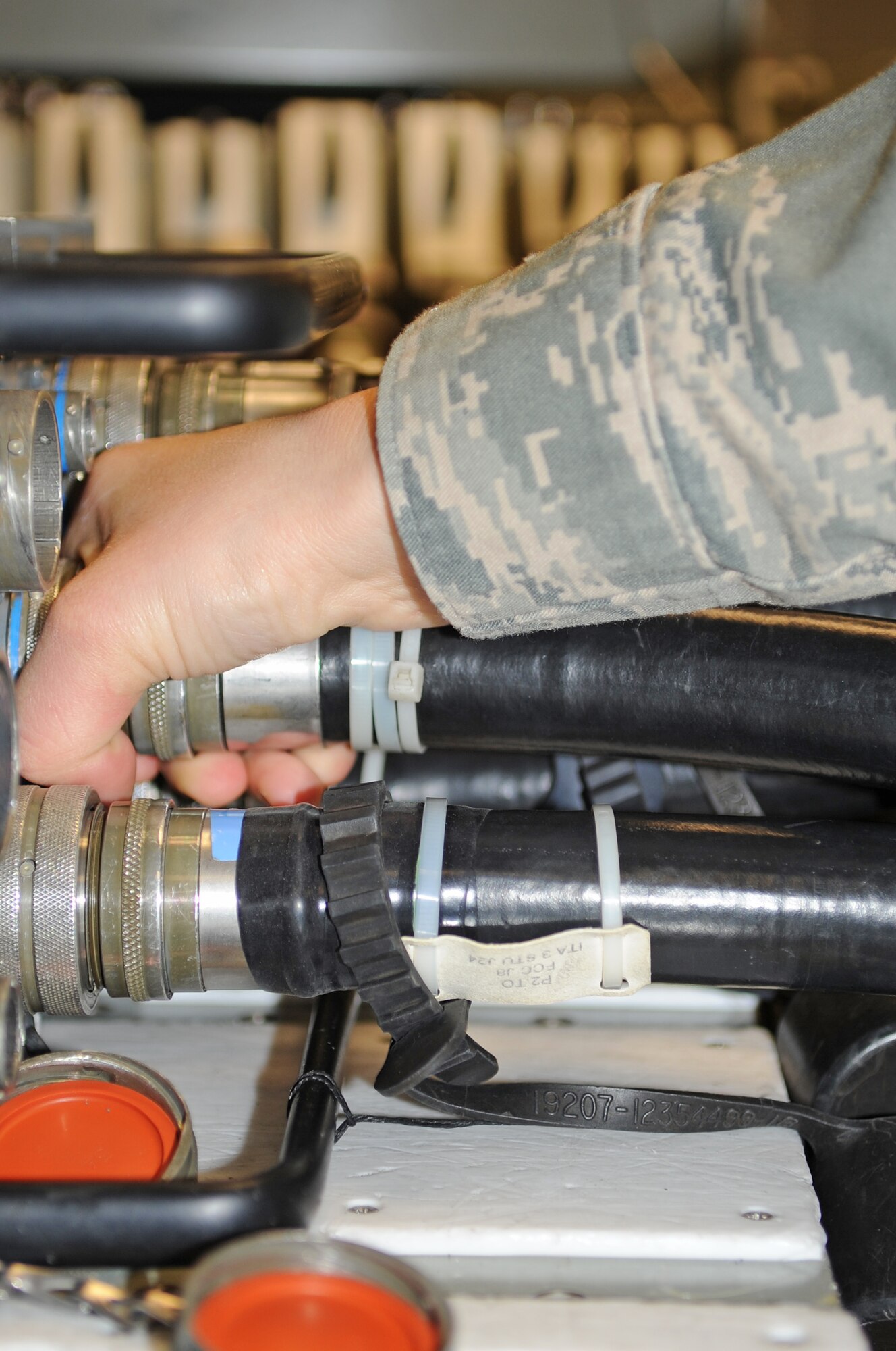 U.S. Air Force Senior Airman Tiffany Schenk, 4th Component Maintenance Squadron intermediate avionics specialist, removes a flight control computer from an interface tester on Seymour Johnson Air Force Base, N.C., Jan. 8, 2013. The avionics shop uses interface testers to pin-point faulty components on all equipment that comes through their shop. (U.S Air Force photo/Airman 1st Class Gino Reyes/Released)